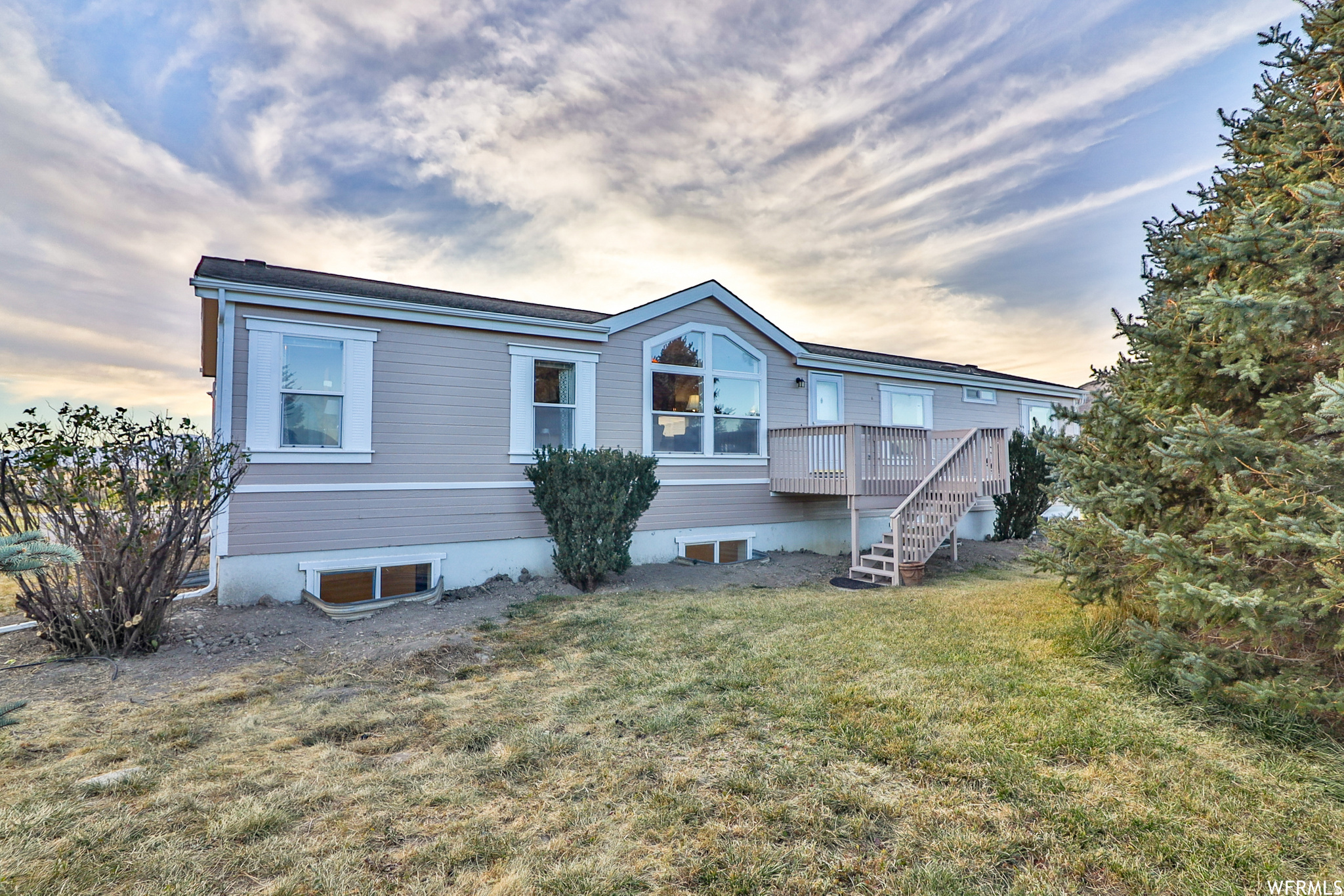 Beautiful spacious home on a sprawling property of nearly 5 acres!  Master Bedroom on main level with master bathroom including tub, shower, and double vanity. Spacious kitchen and dining room with vaulted ceilings. Main level also has 2 other large bedrooms, 2 family rooms and 3 decks outside to enjoy the beautiful mountain views. Finished basement has a walk out entrance, 4 additional bedrooms, an office, 11/2  bathrooms, additional washer and dryer, and huge family room. There is plenty of room to add a 2nd kitchen and separate living space if wanted. The roof was done in the last couple of years. Mature trees throughout the property as well as a chicken coop, storage shed, greenhouse, and a sports court. The back half of the property is fenced and can be used for horses or other animals.