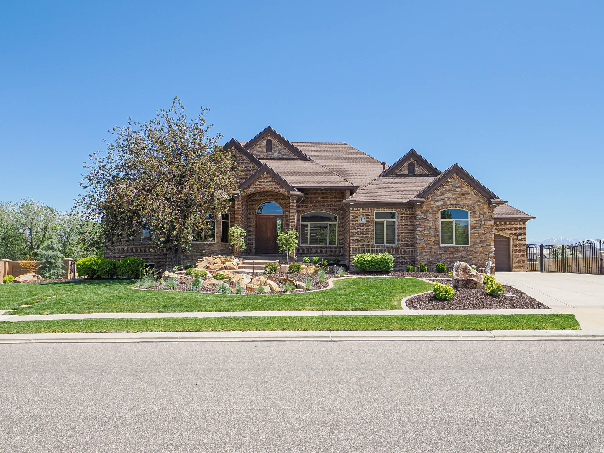 This is not your typical luxury home-this is a fully built-out lifestyle property designed for space, function, and flexibility. Situated on a full acre in Bluffdale, this custom estate offers a rare combination of high-end living and real-world usability-featuring a 2,000 sq ft RV garage with 14' doors, a dedicated workshop, and a pasture ready for horses or additional use. Inside, the home delivers over 6,500 sq ft with vaulted ceilings, expansive living spaces, and a layout ideal for both everyday living and entertaining. A second kitchen and walkout basement create the perfect setup for extended living, guests, or multi-generational use. Step outside to a heated in-ground pool, mature landscaping, and unobstructed mountain views-offering privacy and space that's increasingly hard to find along the Wasatch Front. For buyers who need more than just square footage-this property delivers versatility, storage, and lifestyle in one complete package.