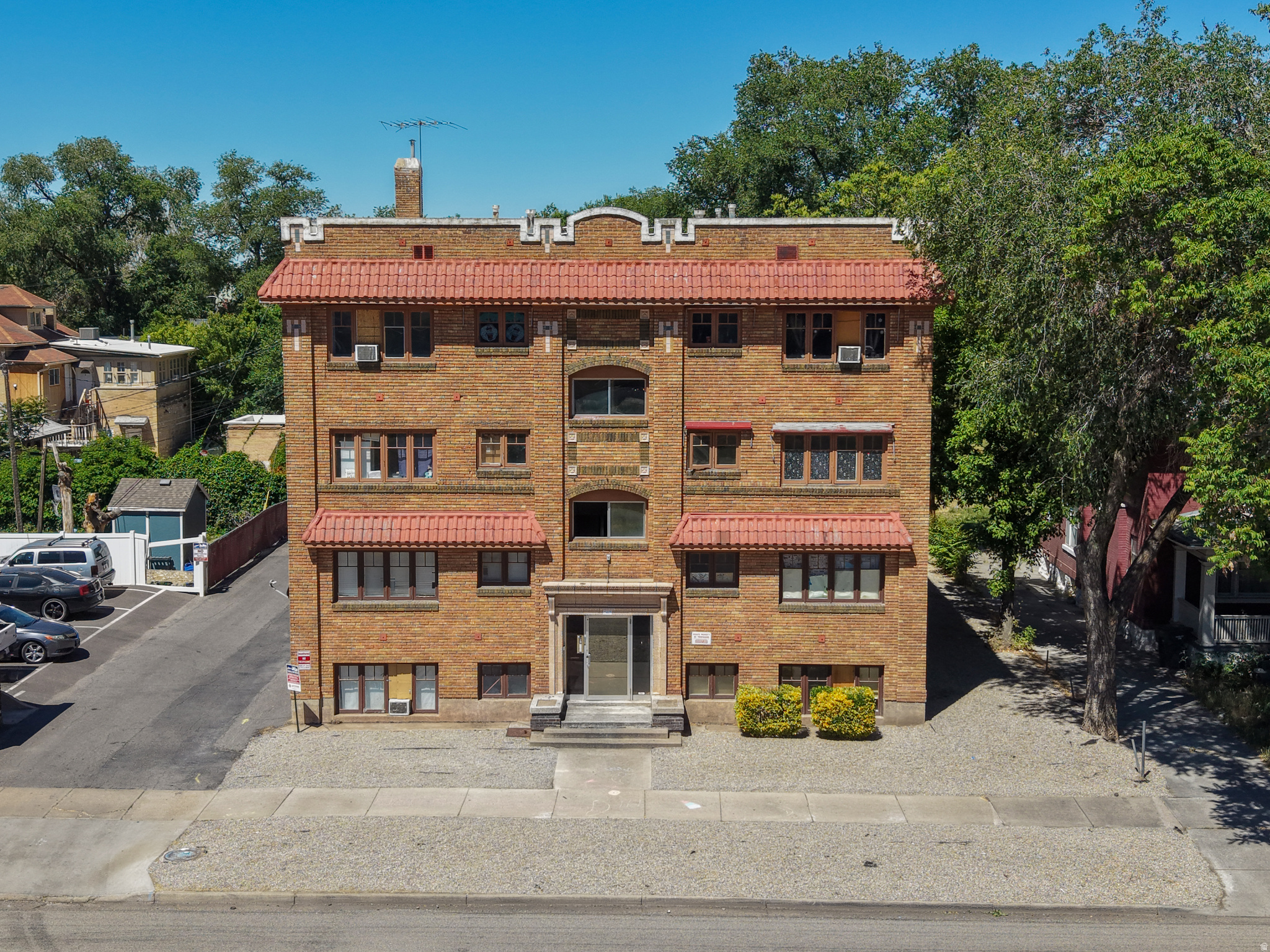 Fontanelle Apartments is a 10-unit historic multifamily asset located at 2465 Monroe Boulevard in Ogden, Utah. Built in 1924 and listed on the U.S. National Register of Historic Places, the property is a three-story building constructed in the Spanish Colonial Revival and Prairie School architectural styles. The property consists of four oversized one-bedroom units and six three-bedroom units. The four one-bedroom units are garden-level, partially above grade. The six three-bedroom units are spread two per floor across the upper levels. A drop-down basement below the concrete deck at the rear of the property houses shared laundry, mechanical systems including the furnace and hot water heater, and additional tenant storage. There is also exterior space at the rear of the site with value-add potential for carport construction. The seller has completed significant capital improvements including a new roof, full electrical rewiring with updated panels, and complete replumbing throughout the building, substantially reducing near-term capex exposure for an incoming buyer. The property operates under a RAD-converted Project-Based Voucher (PBV) HAP contract through the Ogden Housing Authority, providing a 15-year term of government-backed rental income with annual rent renegotiation rights. Current contract rents are $1,142 per month for one-bedroom units and $1,697 per month for three-bedroom units. Five of nine occupied units are HCV tenants operating under the PBV contract. The 10th unit is currently vacant and represents immediate upside, either by re-leasing into the PBV program or converting to market-rate tenancy. Three-bedroom units are in high demand in this submarket, and units renovated to market-rate condition can command rents meaningfully above current contract levels. The PBV contract allows the owner to renegotiate rents annually or terminate and convert individual units to market rate as they turn over, giving a buyer optionality to blend and extend or reposition over time.  At an asking price of $2.1 million, the property is offered at $210,000/unit, a 5.61% cap rate.