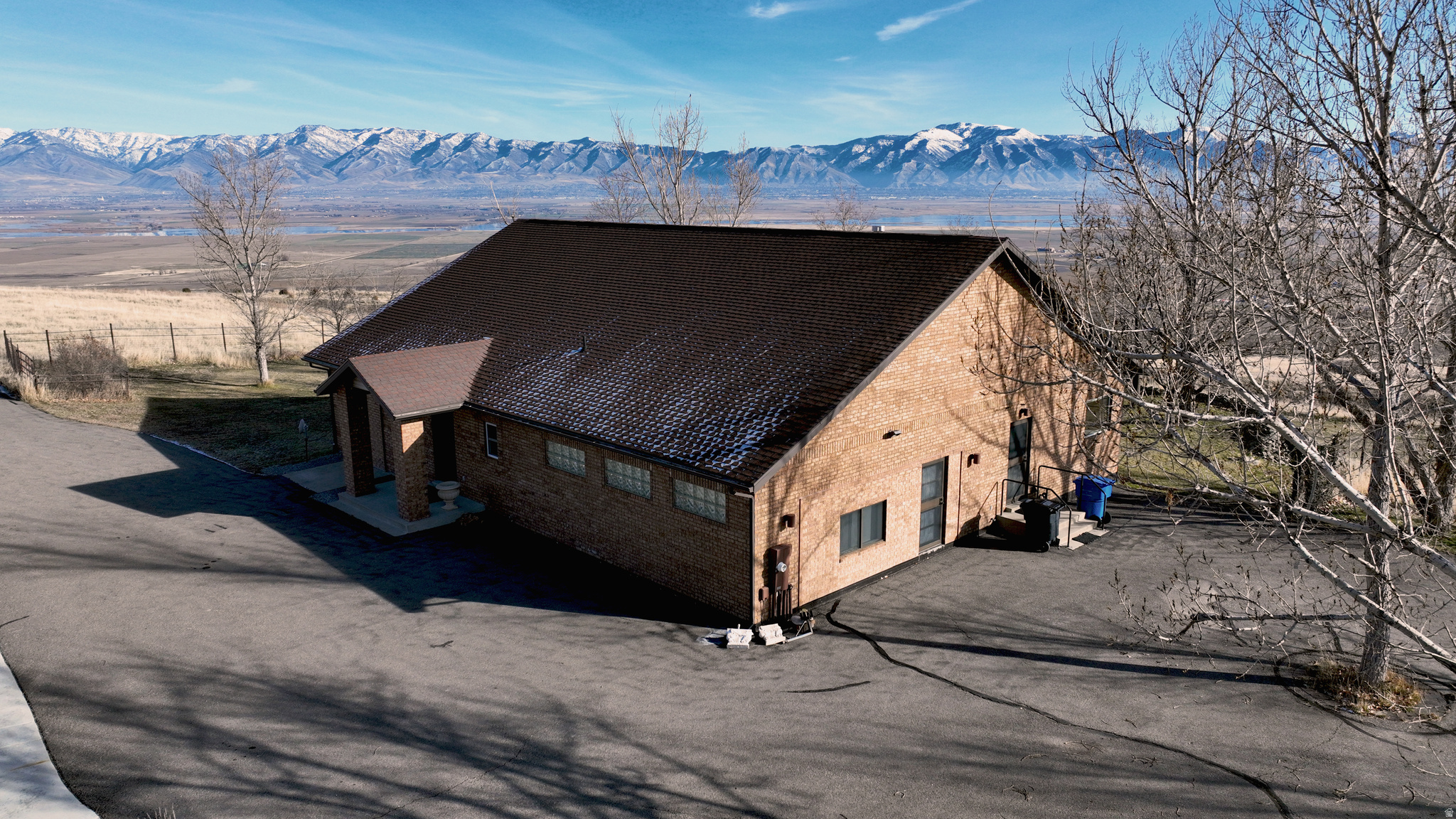 Private Cache Valley Horse Property with Unmatched Views This exceptional 75.41 acre horse property offers complete privacy and unobstructed views that can never be built out. Fully fenced with established trees and vegetation, the land attracts abundant wildlife and sits directly beneath a migratory bird flyway. Located just 15 minutes from Logan and I-15, it provides the perfect blend of seclusion and convenience. The ranch is fully set up for horses and livestock, featuring an automatic iron entry gate, asphalt driveway, round pen, and a large barn with high ceilings, hay storage, tack room, water, electricity, and easy paddock access. A four-bay garage accommodates large vehicles and equipment. The 2,151 sq ft home offers an open floor plan with vaulted ceilings, hardwood floors, a gas fireplace, and large windows showcasing stunning views of the Wellsville Mountains. A spacious patio with a fire pit is ideal for gatherings. The property also produces yearly income and benefits from greenbelt tax status. A rare opportunity to own a peaceful, scenic, and turn-key horse property in Cache Valley.