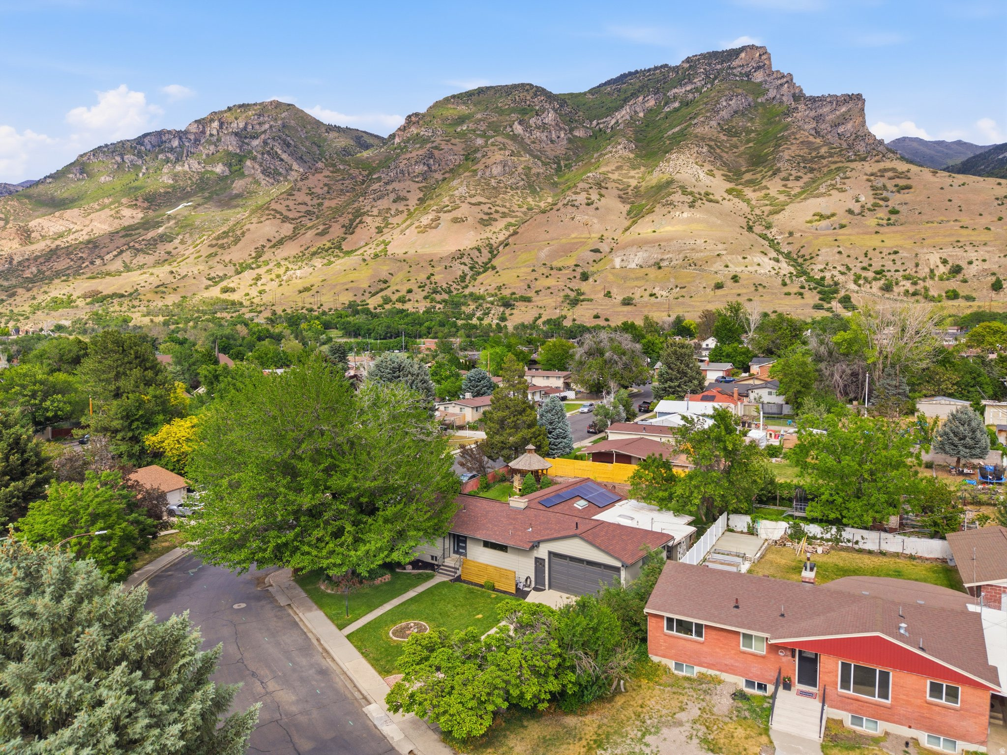 Gorgeous suburban homestead with an amazing kitchen and light-filled gathering spaces. Mountain views and covered back patio to enjoy them from. Multiple fireplaces and large workshop for your bikes, paddle boards, and other outdoor toys. Updated in all the right ways. Plenty of land for gardening, chickens or honey bees.  The basement has a kitchenette and separate entrance.   Hop on a trail for a adventure in the foothills on the weekend and you still have easy access to the freeway for your quick commute to work. Square footage figures are provided as a courtesy estimate only and were obtained from county records.  Buyer is advised to obtain an independent measurement. Call today to schedule your showing.