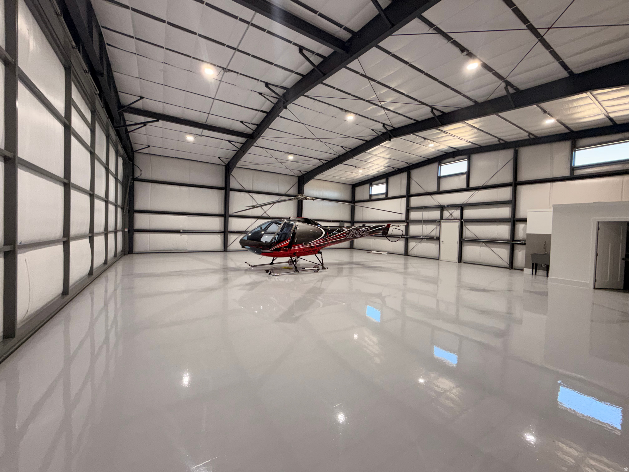 Welcome to this Brand New, Immaculate and unique 55' x 50' Hangar in Brigham City! Great and convenient location. Amazing Mountain Views. Step inside and enjoy high-end finishes. This hangar comes equipped with an Electric Water Heater, Lighting, 120V & 220V connections, Hydraulic Power Lift Door, nicely finished Bathroom with Shower and more! Seriously, such great quality building and hands down the best Hangar around! Door opening: 50'x15'. Two man door covered entrances with timberframe! Equipped with Windows as well, 9 LED Ceiling Lights, Exterior Flood Light and even Epoxied Flooring! Insulation of R19 in the walls & 2 Layers of R30 in ceiling, keeps the temperature inside just perfect. Welcome to your New Hangar! (Information deemed reliable and provided as courtersy. Buyer and/or buyer's agent advised to verify any information buyer deems necessary.)