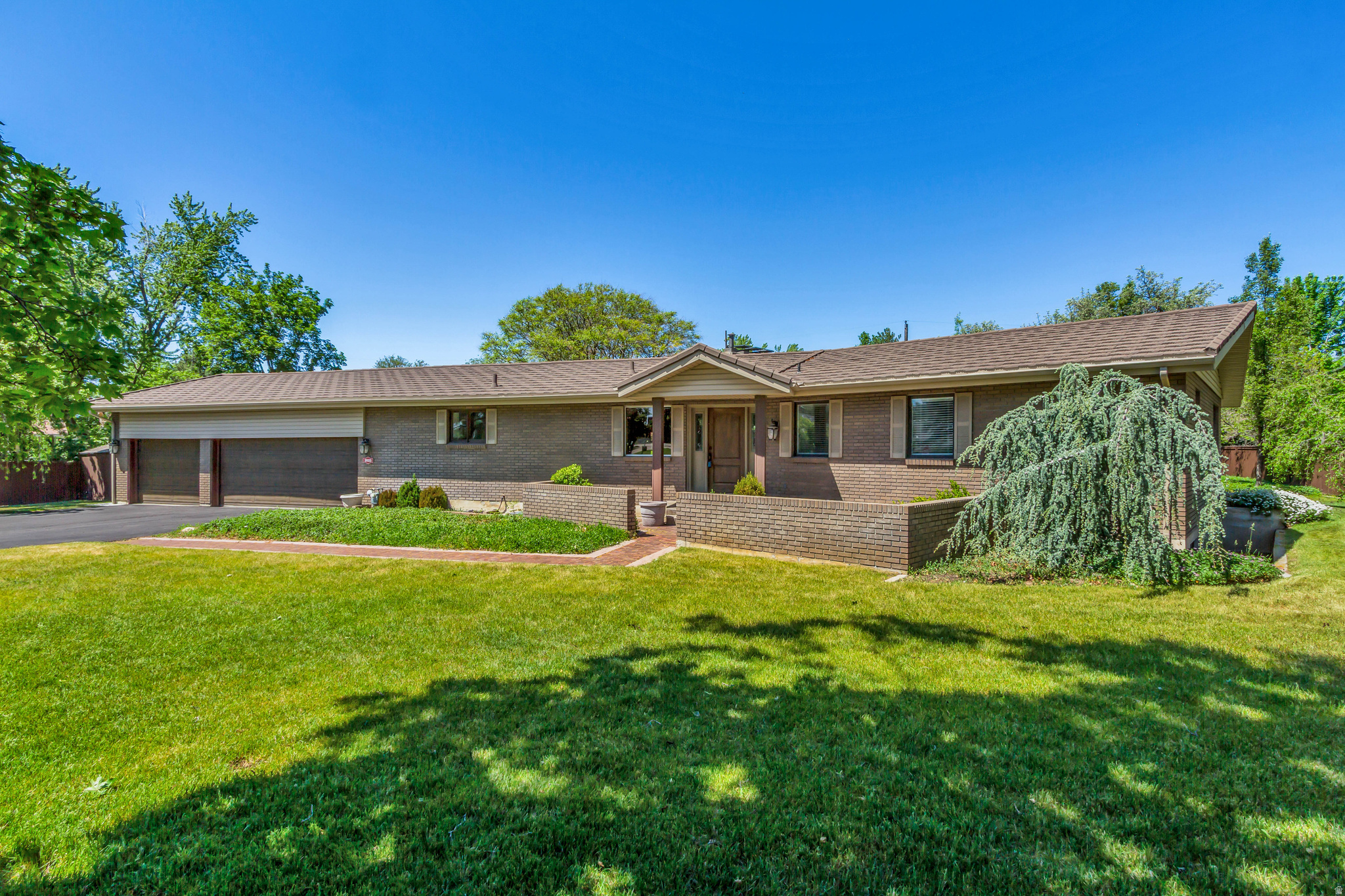 Tucked away in one of Holladay's most convenient and established locations, this sprawling rambler sits on a quiet private lane surrounded by mature trees, lush landscaping, and the kind of timeless setting that's becoming increasingly hard to find. Meticulously maintained, the home offers incredible bones, comfortable living spaces, abundant storage, a rare 3-car garage, and sits on a spacious .51-acre lot. The home also features a separate basement entrance with hookups for a future kitchen, creating flexibility for a secondary living space, mother-in-law suite, guest quarters, or expanded entertaining space. The setting feels secluded and private while still being incredibly connected, just minutes from Downtown Holladay, the new Holladay Hills development, freeway access, Big and Little Cottonwood Canyons, downtown Salt Lake City, and Salt Lake City International Airport. Surrounded by established architecture, tree-lined streets, and stunning Mount Olympus views, this property offers a rare opportunity to enjoy the home in its current charm or renovate and create your own long-term vision. Properties with this kind of setting, lot size, and potential rarely come available in Holladay. Reach out today for a private showing. Buyer/Buyer's Agent to verify all information.