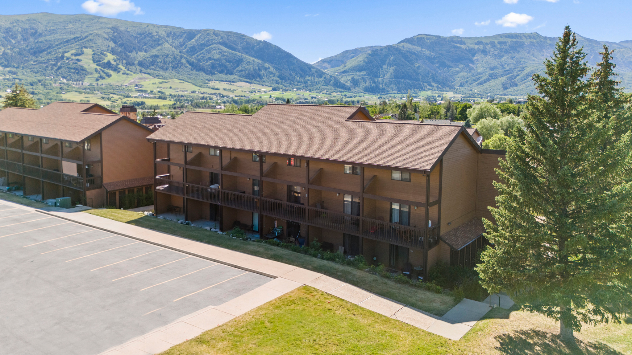 What if everyday living felt more like a mountain retreat? This rare top level Wolf Lodge residence offers sweeping mountain, valley, and water views that create an at home escape buyers are seeking in today's market. From the covered deck, enjoy peaceful mornings overlooking Ogden Valley, then return after a day of adventure to the warm glow and crackle of the fireplace. Vaulted ceilings and abundant natural light enhance the home's open, inviting feel, while the thoughtfully designed layout offers 3 bedrooms and 2 baths with space to relax, gather, and recharge. The kitchen serves as the heart of the home, perfect for everything from casual breakfasts to hosting friends after a day on the slopes, trails, or water. Today's buyers value stability and freedom from unexpected ownership costs. The professionally managed HOA covers exterior maintenance, snow removal, water, sewer, trash, insurance, and on site management, helping protect both your time and budget from future maintenance surprises. What truly makes this home memorable is the combination of panoramic views and resort style amenities that few properties can match. Residents enjoy access to a pool, spa, sauna and steam room, fitness center, clubhouse, tennis courts, picnic areas, and beautifully maintained grounds. As one of the few top floor residences in Wolf Lodge offering such dramatic scenery and lifestyle amenities, this is a rare opportunity to enjoy low maintenance mountain living with the perfect balance of comfort, convenience, and year round recreation.