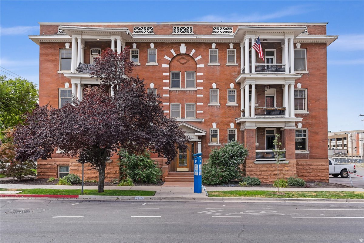 Highly sought-after top-floor corner condo in the historic Sampson downtown Salt Lake City building, offering city and mountain views from a recently restored balcony. Perfectly positioned within walking distance to restaurants, shopping, theaters, and TRAX light rail, this home offers the convenience of city living with timeless character.  Inside, original details-including newly refinished hardwood floors, beautiful wood door frames, baseboards, and a built-in hutch-reflect the home's historic charm. High ceilings and natural light create an inviting, spacious living area.  The thoughtfully remodeled kitchen features updated electrical and plumbing, new cabinetry, countertops, appliances, and an in-unit washer and dryer. The remodeled bathroom also includes updated plumbing. Additional improvements include attic insulation and a rare private backyard garden space-an unexpected retreat in the heart of downtown.