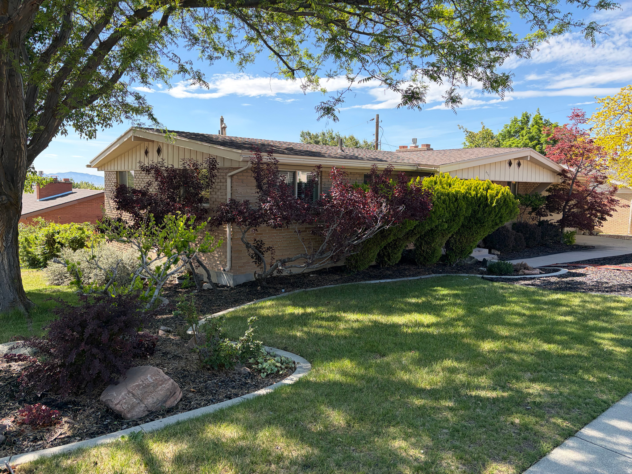 Nestled in a highly desirable East Bench neighborhood, this exceptional home perfectly blends modern upgrades with outdoor efficiency. The beautifully landscaped yard is designed for low-water maintenance and comes complete with secondary water access. Inside, the walk-out basement offers excellent potential for a private mother-in-law apartment. Every major system is meticulously updated, featuring a newer tankless water heater, central vacuum, an upstairs gas fireplace, and a cozy downstairs wood-burning fireplace. There's also an unfinished portion of basement that can be finished for a fourth bedroom. This is a rare, move-in-ready opportunity in a premier location! Owner/agent.