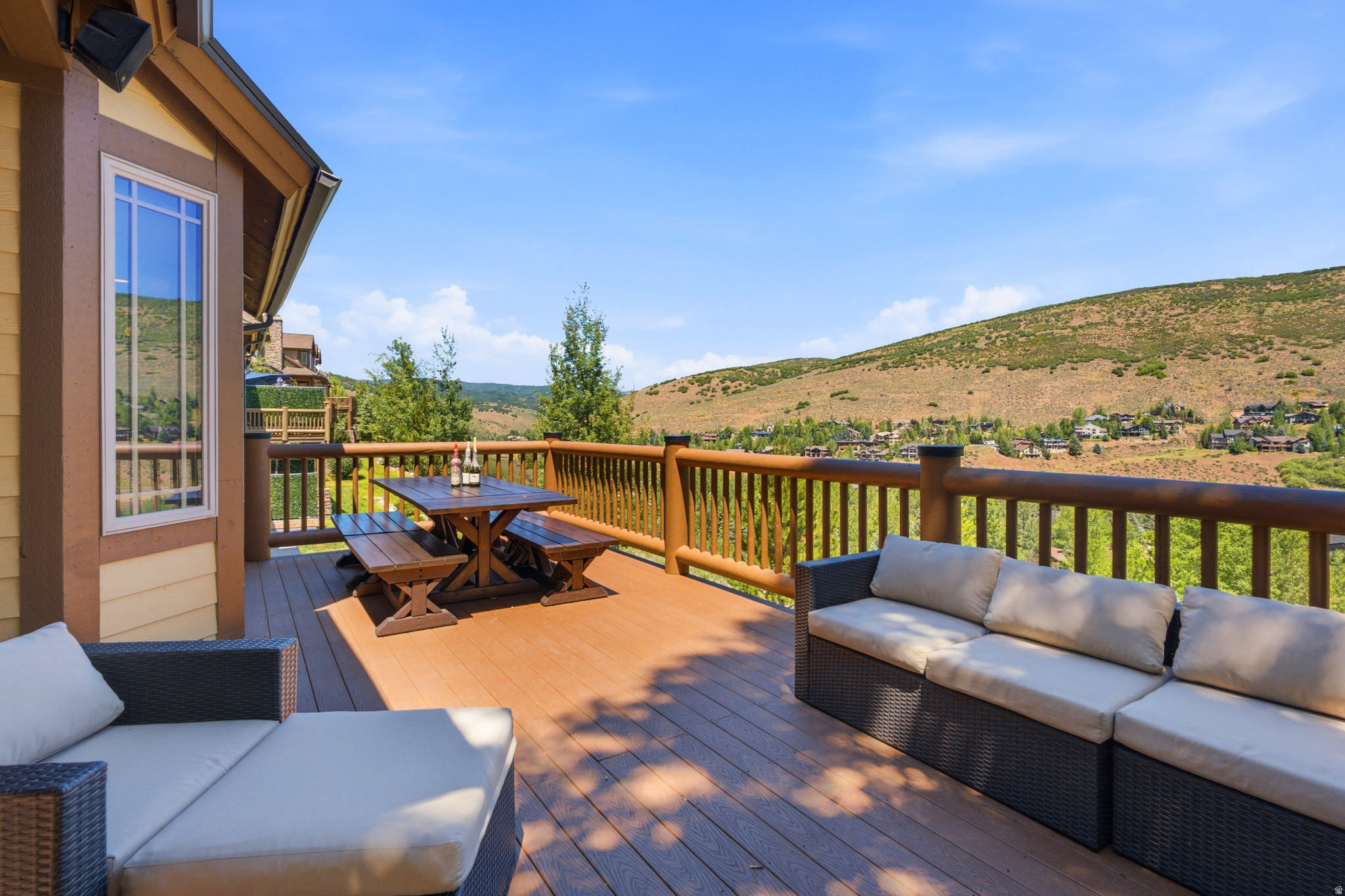 Perched above Jeremy Ranch, this highly sought after and rarely available Canyon Links downhill end unit, featuring an expanded deck with sweeping golf course and mountain views. The main level welcomes you from either the front door or garage into a bright, open great room with newer flooring, a dramatic two story fireplace, a well appointed kitchen, and a dedicated dining area. Large windows and an expansive deck create a seamless indoor outdoor living and capture the stunning natural surroundings.  Designed for entertaining and taking in the scenery.   Upstairs, you'll find two generous bedrooms, including the primary suite with breathtaking views, a luxurious  ensuite bathroom with dual vanity, walk in closet, and a separate jetted tub and shower.  A second bedroom, full bath, and convenient laundry room complete the upper level. The walkout lower level features a generous family room with fireplace, third bedroom, full bath, custom wine cellar/storage room, and direct access to a covered patio with hot tub and private lawn with exceptional views. Located in the heart of Jeremy Ranch, Canyon Links provides unbeatable access to hiking and mountain biking trails, the Jeremy Ranch Golf Club, restaurants, schools, world class skiing, and is just 20 minutes to Downtown Salt Lake City. Notable upgrades include:  Rebuilt deck with new log railings, structural posts, and Trex decking  New roof and heat tape  Water softener  Dish Washer  Several replaced windows  Newer interior flooring and paint  Updated garage flooring and paint This home combines exceptional views, quality updates, and an unbeatable location make this one of Canyon Links' premier offerings.