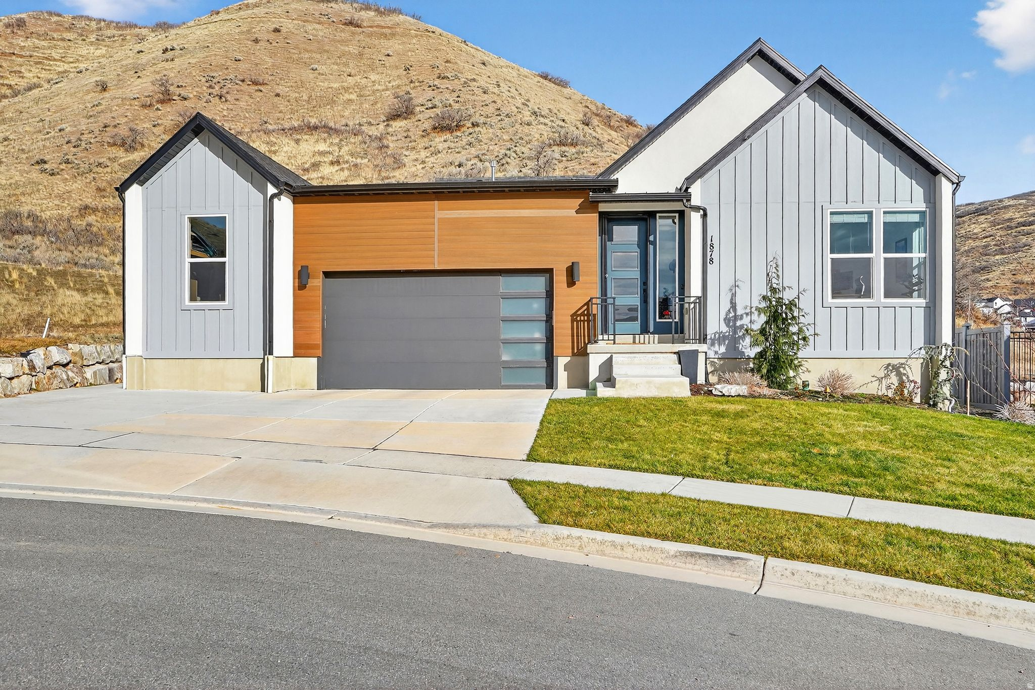 Nestled against the hillside, this striking modern home offers refined living against a stunning mountain backdrop. Inside the open concept main level is filled with natural light and showcases 9 ft ceilings, upgraded flooring, recessed lighting and a thoughtfully designed living space perfect for both everyday living and entertaining. The chef's kitchen is a standout featuring custom cabinetry, large center island, high end appliances with double oven, gas cooktop, quartz countertops and stylish tile backsplash that adds character and charm. The primary suite offers a peaceful retreat with generous space, large windows and ensuite bath. Downstairs the fully finished basement provides a spacious family room with endless possibilities, 2 guest bedrooms and bath. Step outside to a private backyard with peaceful mountainside views. Enjoy community amenities such as clubhouse, pool, tennis and basketball courts, multiple parks and easy access to scenic trails.