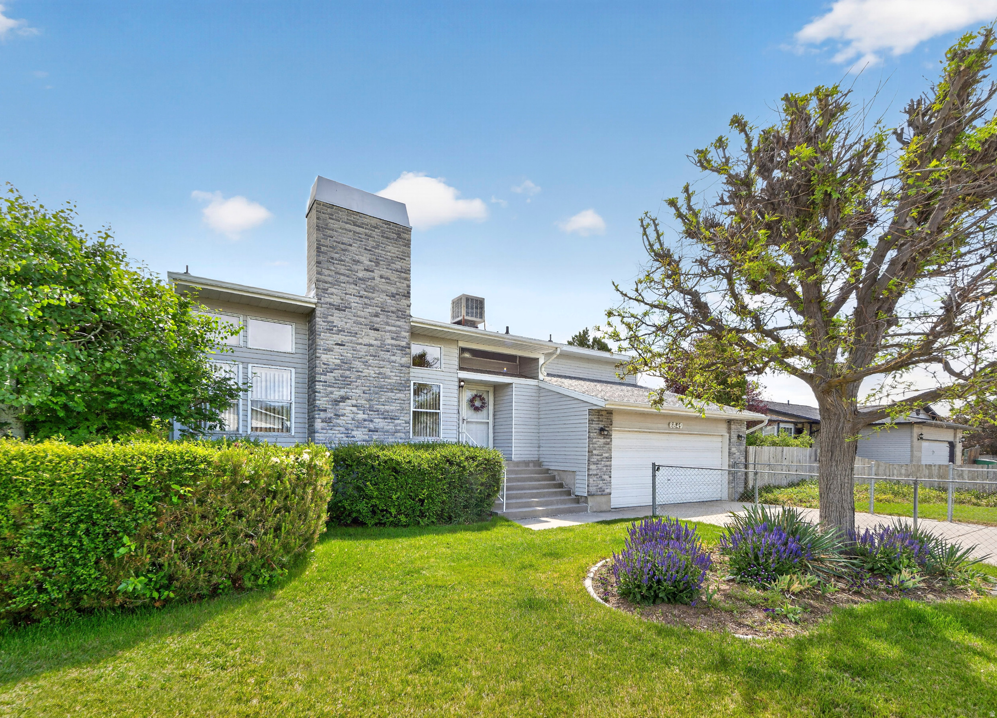 NEW PRICE! LIGHT, BRIGHT, OPEN W/the most amazing views! Cathedral ceilings, walk-out basement w/oversied bonus rm & separate bed/bath. Backyard is an entertainer's dream come true; large deck, private garden spaces & grassy areas. Storage/food cellar. Welcome home!