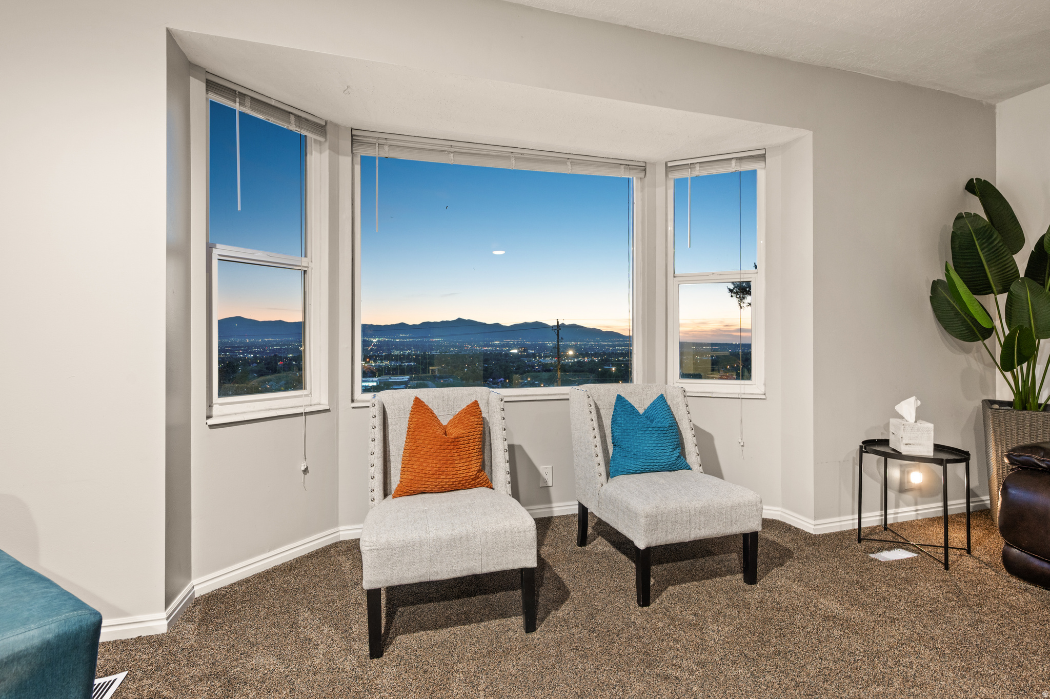 Perched on Sandy's coveted east bench ridgeline above 1300 East, this nearly 5,000 SqFt home sits elevated against the Wasatch foothills with sweeping panoramic views of the Salt Lake Valley, city lights, and surrounding mountain peaks. Expansive picture windows flood the open living spaces with natural light while framing breathtaking views from nearly every room. Multiple gathering areas, spacious bedrooms, and a perfectly positioned deck and patio create an ideal setting for entertaining or relaxing year-round. Outdoor living offers two distinct experiences - panoramic valley and city views to the west, plus dramatic mountain backdrops, shaded evenings, and fire pit gatherings from the front patio. The flexible floor plan includes 7 bedrooms, 5 bathrooms, a second kitchen, and a walk-out basement with separate entrance and strong rental history, offering exceptional potential for multigenerational living, guest accommodations, or additional income. Sandy City allows and can approve short-term rental use, creating a rare opportunity to offset monthly ownership costs. Located in one of Sandy's most sought-after east bench neighborhoods with quick access to world-class skiing, hiking, and mountain trails while remaining conveniently connected to the heart of the Salt Lake Valley.