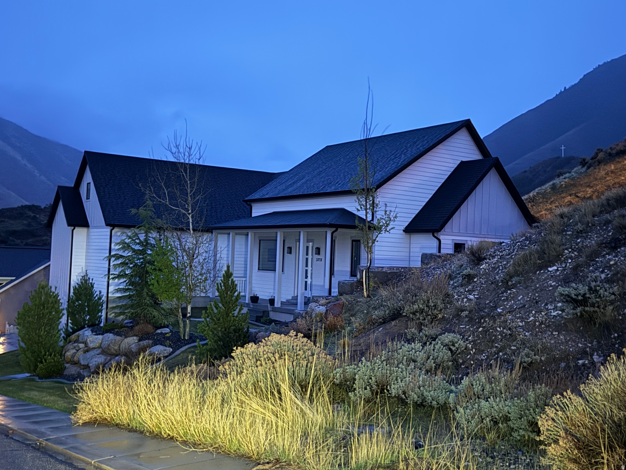 Exceptional 2020 custom home in prestigious Oakridge Cove with breathtaking mountain, valley, and lake views. Built by a high-end custom builder as a personal residence, this property offers quality craftsmanship, a spacious open floor plan, and remarkable flexibility for a variety of living arrangements. The lot extends all the way back to Eagle Rd. and offers an incredible setting for a future pool with stunning 360-degree views. The main living area is open and expansive, with 12-foot ceilings, abundant natural light, and a beautiful marble-surround fireplace anchoring the living, dining, and kitchen spaces. White shutters accent all above-grade windows. The oversized island provides generous workspace and gathering space in the kitchen, while striking granite countertops, custom tile work, and top-of-the-line appliances add to the home's elevated design. All appliances are included, including those in the main kitchen, lower-level kitchen, and both laundry rooms. With 78 bedrooms and en suite baths for each secondary bedroom, this home offers an exceptional layout with privacy and comfort throughout. Special-use spaces include an office, gym, and full bath on the second level. The basement lives like a second home, featuring a large theater room, second kitchen, laundry area, three bedrooms with en suite baths, and two oversized storage rooms. Additional highlights include designer closets throughout, spacious walk-in closets in both the main-level and lower-level primary suites, a Wolf gas/electric double-oven range, tankless water heater, Nuvo water softener, gas stub for bbq, programmable LED lighting, two AC units, two electric dryer hookups, and two washers. Energy-efficient construction features include one inch of urethane foam in all exterior walls and rim joists, plus 3.5 inches of urethane foam in the ceilings of both cold storage areas, helping improve comfort and reduce energy costs.