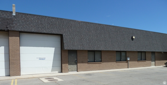 Clean industrial space with private office (~50 sq ft), overhead door, and rest room. Features 400-amp electrical service (two 200-amp meters). Strictly no automotive uses permitted