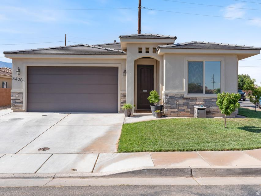 A Backyard You'll Actually Want to Spend Time In | Built in 2018 in Zion's Gate Estates, this well-kept 3-bedroom, 2-bath home offers comfortable living with a backyard that steals the show. Mature grapevines, grow boxes, and attractive landscaping create a private outdoor space that's full of charm and surprisingly hard to leave. Inside, the home is clean, bright, and easy to maintain, with a functional layout that makes the most of its space. Outside, there's room to garden, relax, entertain, or enjoy the kind of yard that feels like someone truly cared about it. The corner lot adds a little extra breathing room, while shopping, dining, and everyday conveniences are just minutes away. Comfortable, well cared for, and paired with a backyard that's every bit as inviting as the home itself.
