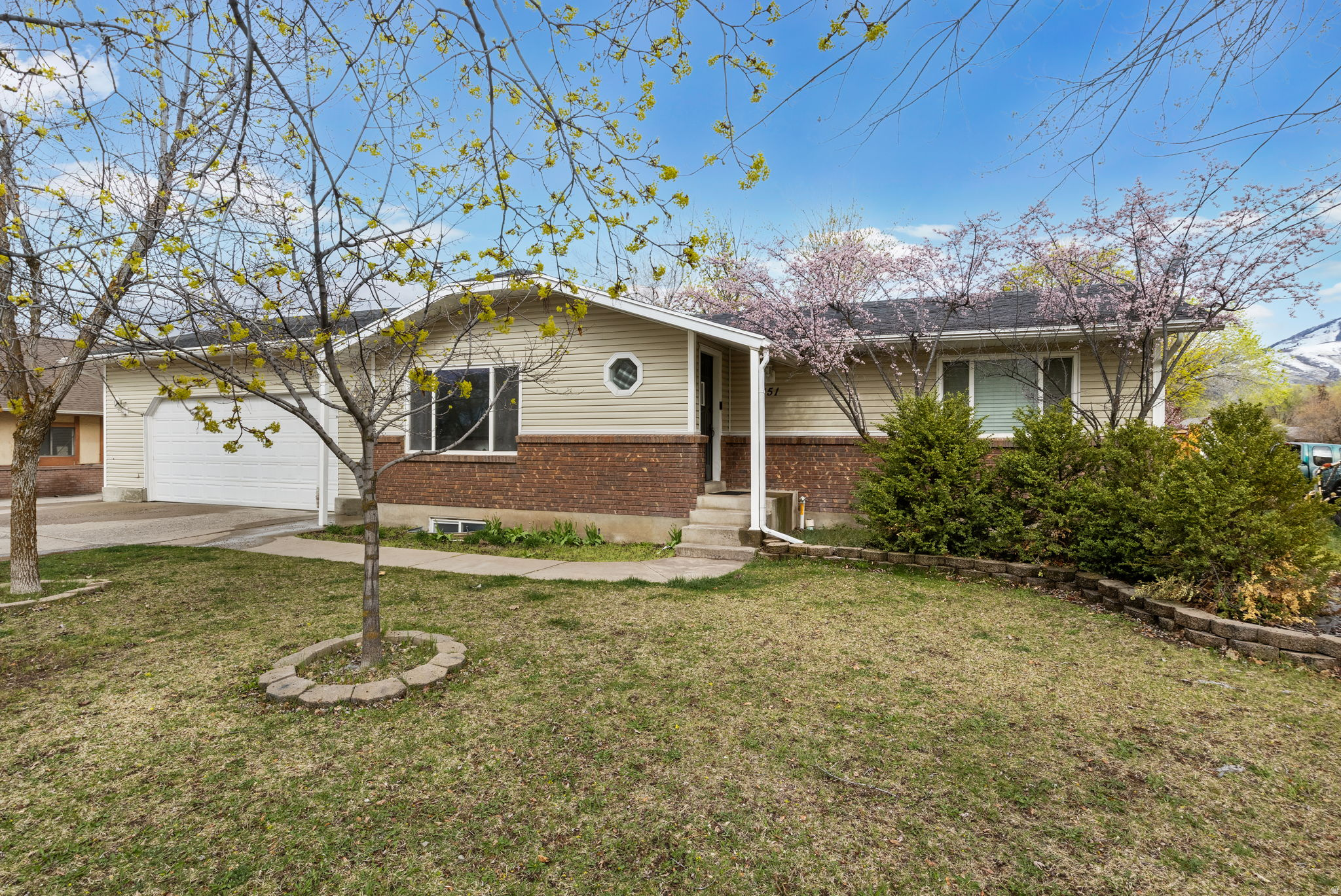 OPEN HOUSE SATURDAY 6/13:  9:30-11:30  This 3-bedroom, 3-bathroom Main level Living Rambler home in Hyrum, Utah offers 2,026 sq ft of functional living space with a walkout basement and mother-in-law apartment potential.  Situated on over a quarter acre with mature trees and sweeping mountain views, the property delivers the space, privacy, and outdoor lifestyle that Cache Valley buyers are searching for. The oversized deep garage with extra ceiling height accommodates large vehicles, a workshop, or serious storage needs and dedicated RV and boat parking set this listing apart from comparable inventory at this price point. Location is a standout: just 5 minutes to Hyrum Reservoir for boating and paddleboarding, 10 minutes to Blacksmith Fork Canyon for hiking and fishing, and convenient access to Logan schools, shopping, and dining via US-89. Whether you're a first-time buyer building equity in Northern Utah, an investor targeting value-add residential in Cache Valley, or a growing family needing room to spread out, this home checks the boxes that matter. Properties with this footprint, lot size, and proximity to outdoor recreation rarely come available in the 84319 market at this price.  Priced to move. Built to last. Welcome to Cache Valley.  Square footage figures are provided as a courtesy estimate only.  Buyer is advised to obtain an independent measurement.