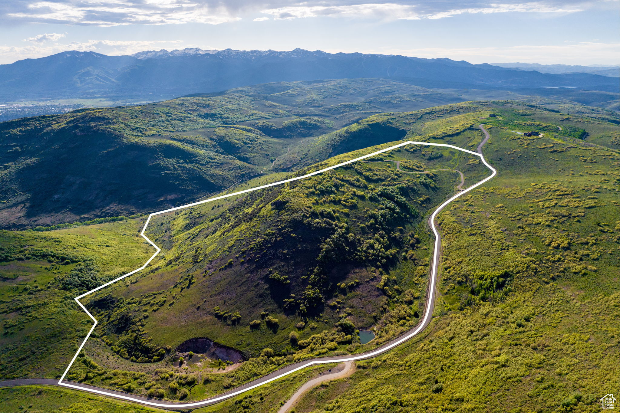 THIS is your chance to own 161 breathtaking acres all to yourself and the perfect spot to build your luxury mountain estate on top of a hill overlooking the entire Heber Valley! Within the gated compounds of the coveted Wolf Creek Ranch community, you get the best of both worlds - privacy and seclusion while also only being 15 minutes from restaurants and grocery stores. In the community your friends will have unlimited adventures for entertainment: fly fishing on 3 stocked ponds and 60 miles of trails for horseback riding, ATV riding, snowmobiling, and hiking. The Ranch abuts the Uinta National Forest, giving you direct private access into 2.2M acres. Just a few minutes outside of the community are Heber and Park City, where you can find world class golfing and skiing, two huge reservoirs for boating, and ample fine dining. There are only 80 lots in the entire ranch and none with as premium of a view as this one. The owner has already invested over $500K moving dirt for the road and landscaping mature trees. Reach out for more information on your future slice of heaven!