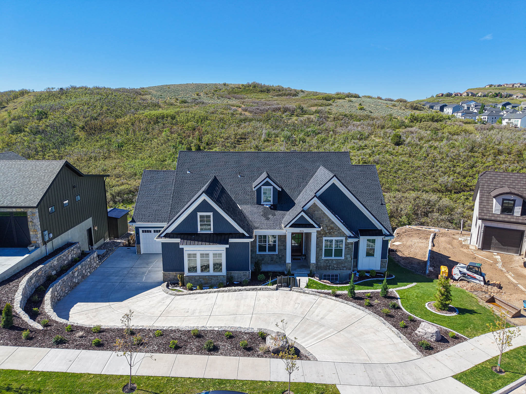 Perched in one of Draper's finest neighborhoods, this exceptional custom luxury residence captures breathtaking, unobstructed views of the Wasatch Mountains and majestic Mount Timpanogos with no backyard neighbors to interrupt the setting. Designed to blend refined luxury with everyday livability, the home offers expansive open-concept gathering spaces paired with timeless craftsmanship and elevated finishes throughout. The heart of the home is a stunning chef's kitchen featuring high-end appliances, custom cabinetry, and seamless flow into the spacious great room - perfectly positioned to maximize natural light and mountain views. A dedicated living room and main-floor office provide flexibility for entertaining, remote work, or quiet retreat. Rich hardwood flooring and beautiful wood windows add warmth and sophistication throughout the main level. The luxurious primary suite serves as a true private retreat with vaulted ceilings, a cozy fireplace, and a spa-inspired bath featuring a freestanding soaking tub, oversized walk in shower, and generous walk-in closet. The fully finished daylight basement expands the home's versatility with a second full kitchen, three additional bedrooms, two bathrooms, a dedicated gym space, and radiant heated basement floors for year-round comfort - ideal for guests, multigenerational living, or entertaining on a larger scale. Outdoor living is equally impressive with extensive site improvements creating a rare, large flat backyard space - all set against spectacular mountain views. Enjoy year-round entertaining from the oversized deck, covered patio, and outdoor fireplace while taking in panoramic views. Additionally, show shoveling is kept to a minimum with the heated driveway for the winter months. a rare opportunity to own a luxury view property in one of Draper's most desirable locations!