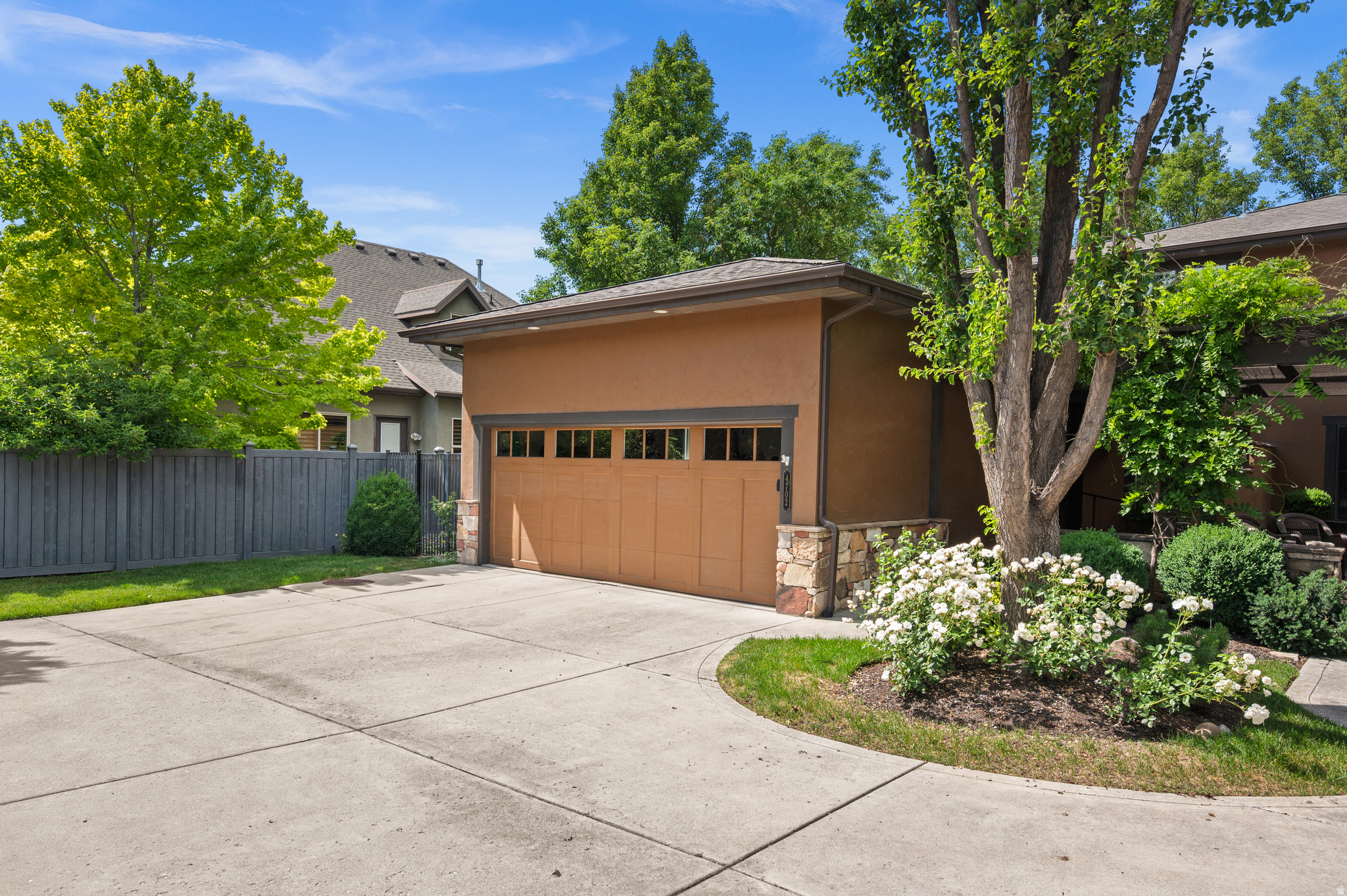 Opportunities like this are rare, an exceptional Prairie-style Townhome in Millrace Park, a gated tight-knit community nestled among the mature trees on the banks of Big Cottonwood Creek. This home is truly a sanctuary from the fast pace of the city outside. Inside, the vaulted ceilings and clerestory windows flood the open living space with natural light. Pristine solid oak hardwood floors anchor the main level, complemented by a native stone fireplace and rich cherry wood cabinetry, lending the home a timeless, distinguished character. The main floor primary ensuite is a genuine retreat, opening directly onto a lush, private patio and secluded backyard - perfect for quiet mornings or effortless entertaining. A newly installed mini split heat pump provides year-round comfort in the two bedrooms and full bath upstairs. Recent upgrades include a new roof, fresh interior and exterior paint, recessed lighting, reverse osmosis water filtration, and a water softener. Generous shelving and cabinets throughout the home and garage meet every practical storage need. Come see for yourself - properties like this rarely stay available for long.
