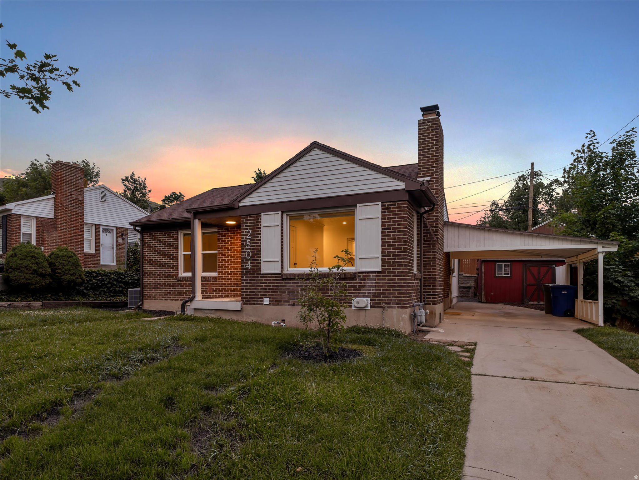 Located in the highly sought-after Country Club Heights neighborhood of Sugar House, this classic red brick cottage perfectly blends timeless charm with modern updates in one of Salt Lake City's most walkable and desirable communities. Ideally situated near top-rated schools, beautiful Sugar House Park, boutique shopping and local restaurants. It is just minutes from the University of Utah, downtown Salt Lake City, Salt Lake City International Airport, and world-class skiing in Park City and the Cottonwood Canyons, this location offers the very best of Utah living. This darling home features 2040 square feet, four bedrooms and two beautifully updated bathrooms. The ideal floor plan includes an open-concept kitchen, a spacious main living room, and a versatile rec room, exercise room, home office, or flex space on the main floor. Thoughtfully updated throughout with toungue and groove laminate flooring, fresh designer paint, stylish lighting, and newer windows, the home feels both inviting and move-in ready. The warm and welcoming living room showcases a large picture window that fills the space with natural light, along with a cozy fireplace featuring a custom mantle and tiled hearth. The gourmet kitchen is beautifully appointed with stainless steel appliances, a gas range, custom white cabinetry, quartz countertops, and a sleek subway tile backsplash. Both bathrooms have been tastefully remodeled with new tile, updated fixtures, modern surrounds, and designer hardware. The finished basement provides additional flexible living space ideal for guests, hobbies, a media room, or home gym. Outside, the private backyard retreat features a deck off the main floor, terraced garden beds, stone patio, automatic sprinklers, mature landscaping, a storage shed, and a lush front lawn. A large driveway and carport provide ample parking and storage for all your outdoor gear. Don't miss this opportunity to own a beautifully updated home in one of Sugar House's premier locations.