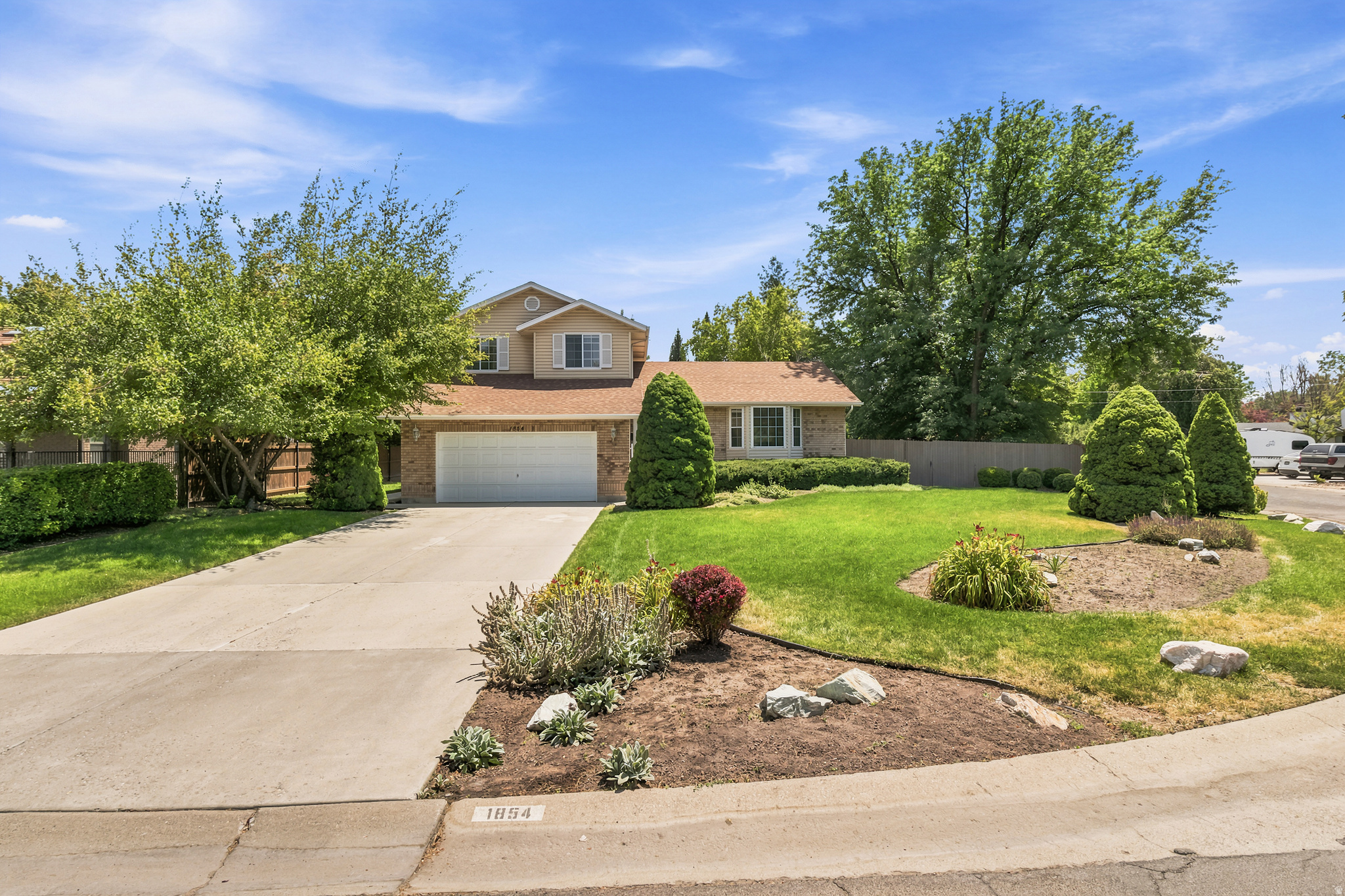 Pristine one-owner home in one of Holladay's most desirable neighborhoods! Built w quality craftsmanship & materials on a beautiful, spacious lot w a nice view of Mt Olympus, this home offers timeless appeal & endless potential with an unfinished basement ready for your vision. Ideally located just minutes from the Holladay Hills redevelopment, Trader Joe's, restaurants, shopping & Cottonwood Country Club. The bright, open main level features a functional U-shaped kitchen w abundant cabinetry & storage, a casual dining nook, a spacious family room, & dual access to the lush backyard, creating seamless indoor-outdoor living. A convenient main-level laundry room & half bath add to the home's functionality. Upstairs offers a generous primary suite w large ensuite bath & dual closets, plus two additional bedrooms & full bath. The unfinished basement offers excellent opportunities w bathroom plumbing already in place, large windows & ample space for additional bedrooms, home office, family room, gym, or any combination to fit your lifestyle.