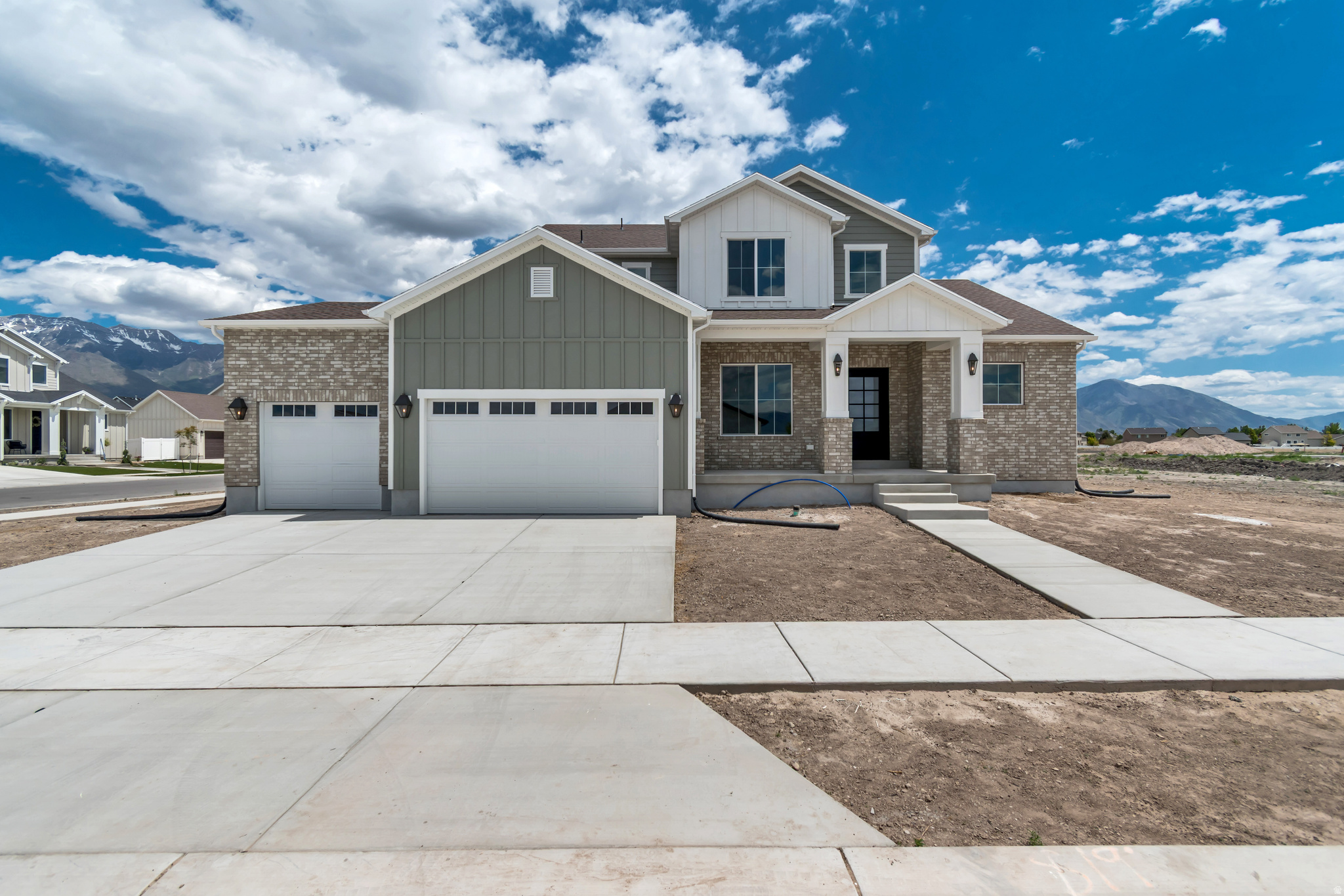 Nestled in a quiet Vineyard neighborhood just minutes from beautiful Utah Lake. Designed for both everyday comfort and unforgettable entertaining, this home showcases exceptional custom finishes and an inviting open gathering space filled with natural light from oversized soaring windows.  Make a statement from the moment you arrive with the oversized front door featuring innovative smart glass technology, allowing you to instantly shift between clear and frosted glass at the touch of a button for on-demand privacy and modern elegance.   The thoughtfully designed kitchen is the heart of the home, featuring a large pantry, custom lighting, beautiful backsplash, oversized quartz island, custom cabinetry throughout, and a stunning custom vent hood. A breathtaking wood staircase serves as a striking architectural centerpiece, adding warmth, character, and timeless design to the home.  Retreat to the private main-level primary suite, where abundant windows create a bright and peaceful escape complemented by a spacious, luxurious ensuite bath. Upstairs, a large landing leads to three additional inviting bedrooms, all with walk-in closets, including one with its own private ensuite, creating the perfect space for guests or multigenerational living.  The expansive unfinished basement offers incredible potential, including a convenient rear walk-up entrance and plenty of room to grow, customize, and make your own.  Square footage figures are provided as a courtesy estimate only and were obtained from county records. Buyer is advised to obtain an independent measurement.