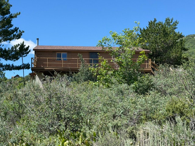Looking for an affordable Bear Lake vacation home? This is it, this classic 1978 log cabin, offering the perfect opportunity to create your own mountain retreat. Ready to use & enjoy today, with the opportunity to add your own personal style and updates over time. The warm log cabin character, featuring a tongue-and-groove interior & the cozy feel of a cabin. Conveniently located just minutes from Bear Lake, National Forest trail access, and Beaver Mountain Ski Resort, this property is ideal for year-round recreation including boating, fishing, hiking, ATV riding, snowmobiling, & skiing. Whether you're looking for an affordable starter vacation home, weekend getaway, or a place to create lasting family memories, this cabin offers value & potential in a sought-after recreational area. No short term rentals allowed in this HOA.