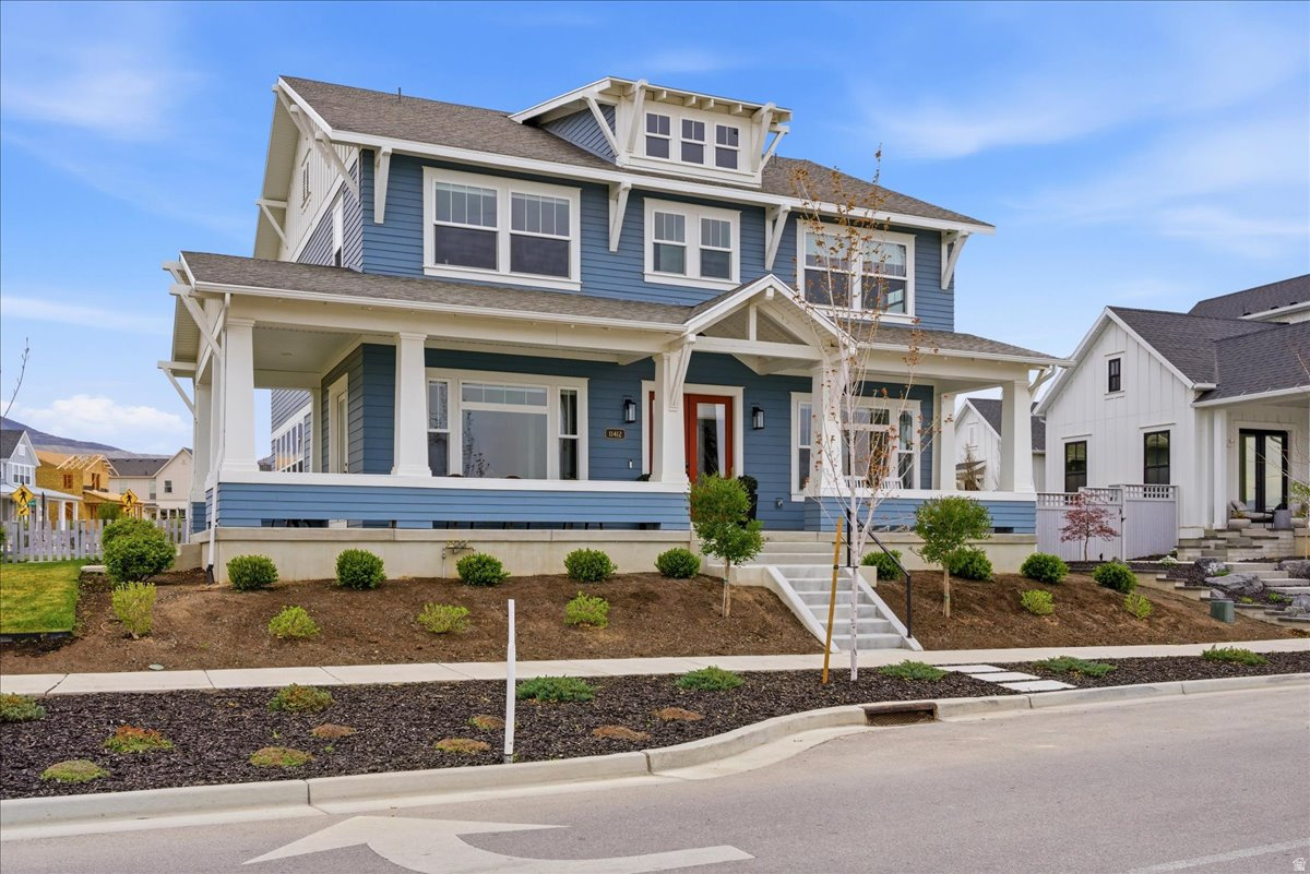 Used as a second residence and lived in for only a few months, this near-new home has been meticulously maintained and offers the benefit of completed construction without the timeline of building. Completed in 2024 and positioned on a premier corner lot-one of the largest along the watercourse-this home sits directly across from the waterways, in South Jordan's Daybreak community, with mountain views and a setting that feels open, quiet, and connected. Immediate access to walking paths and outdoor spaces enhances the lifestyle this location provides. Thoughtfully built by Rainey Homes, it stands apart through craftsmanship and intentional design. Wood-beamed and coffered ceilings, expansive windows, and custom built-ins create a sense of depth, warmth, and natural light throughout. Every space feels considered, elevated, and reflects a level of design rarely found in new construction. The main level is designed for both everyday living and entertaining, with a dedicated office, formal dining room, and a spacious family room anchored by a custom fireplace with a full wall of white oak built-ins. The layout flows seamlessly, defined by clean lines and layered textures. The kitchen is both refined and highly functional, featuring custom cabinetry, a statement hood with pot filler, paneled refrigerator and freezer, double dishwashers, pebble ice machine, oversized island, a generous walk-in pantry, and a dedicated coffee bar. Upstairs, the primary suite offers a true retreat with dual walk-in closets and a spacious, spa-inspired bath featuring extensive cabinetry and storage, a freestanding soaking tub, and an oversized walk-in shower. The fully finished basement expands the home's versatility with a large family room, dedicated gym, wet bar kitchenette, and additional living space well suited for guests or large families. Two laundry rooms-one on the upper level and one in the basement-add convenience and flexibility across the home. Additional features include a thoughtfully designed mudroom with built-in storage, custom window treatments throughout, a three-car garage with EV charging, and an expansive backyard with a large paver patio-set on one of the most usable lots along the watercourse. The home includes a dedicated gym, which is counted as a bedroom. A home defined by craftsmanship, thoughtful design, and a setting that is increasingly difficult to recreate. All furniture is negotiable.