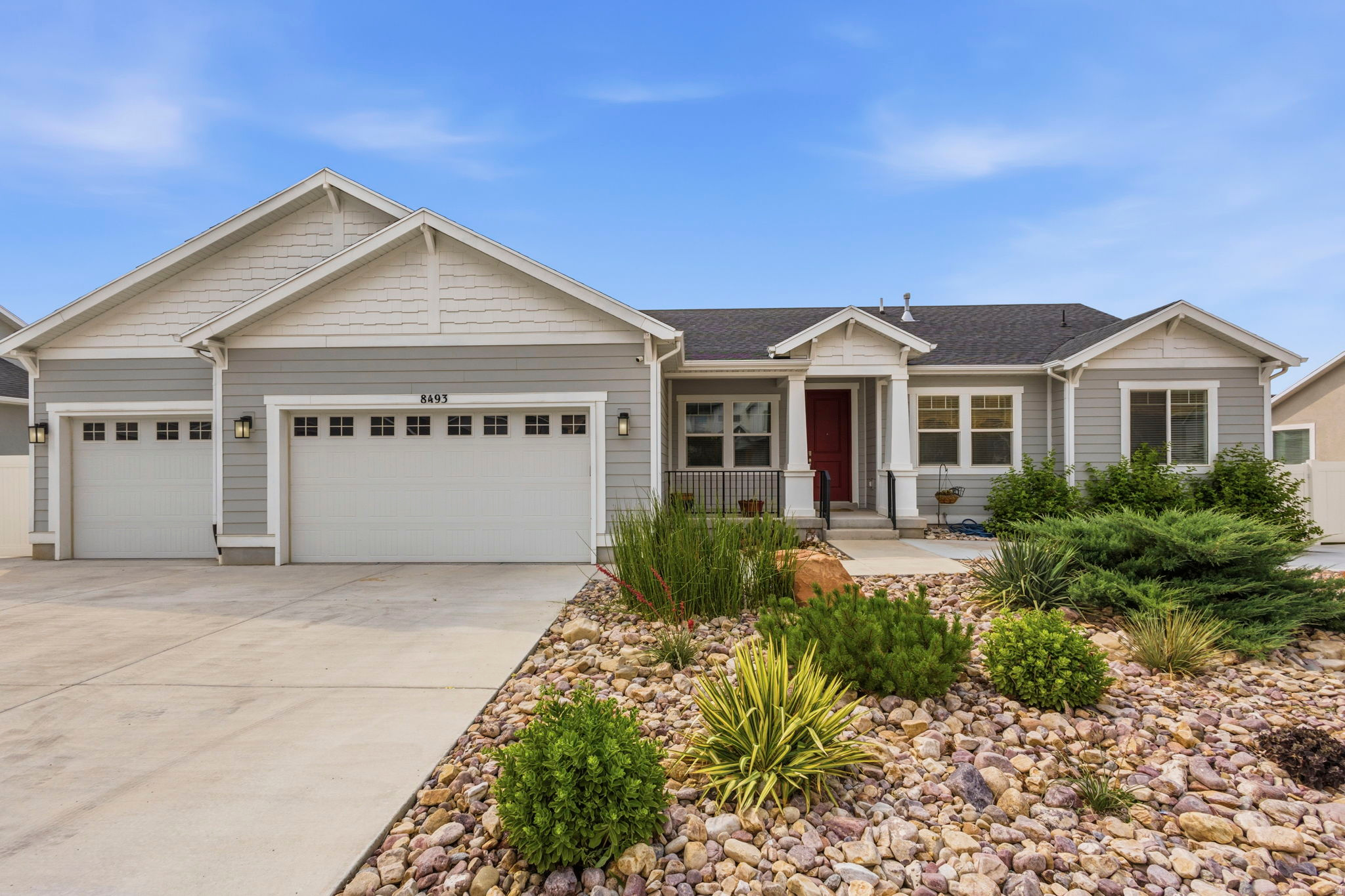 Spacious, versatile, and impeccably maintained, this exceptional 5-bedroom, 4.5-bath home offers the perfect combination of comfort, functionality, and income potential in a quiet neighborhood with stunning mountain views. Inside, you'll find a meticulously cared-for home with generous living spaces and room for everyone. The fully finished walkout basement features a full kitchen, two bedrooms, two bathrooms, private patio and offers excellent potential as a rental, mother-in-law apartment, or multigenerational living space. The oversized garage is a standout feature that includes durable epoxy floors, a built-in workbench, and overhead storage for all your tools and gear. The enclosed third-car bay provides incredible flexibility and can be used as a home gym, workshop, hobby room, man cave, playroom, or additional storage space. Outside, the beautifully xeriscaped property includes valuable .55 acre-feet of water shares and is designed for low-maintenance living. The backyard is perfect for entertaining and relaxing, featuring artificial turf, a gas fire pit, and a stunning cedar pergola equipped with a gas stub-out perfect for a future outdoor kitchen. A heated shed with electricity and a built-in dog washing station adds even more versatility to the property. Whether you need a workshop, home office, studio, pet grooming area, or extra storage, this space can easily adapt to your needs. Don't miss your chance to own this incredibly versatile property with room to grow, space to entertain, and views you'll love coming home to every day.  Square footage figures are provided as a courtesy estimate only. Buyer is advised to obtain an independent measurement.