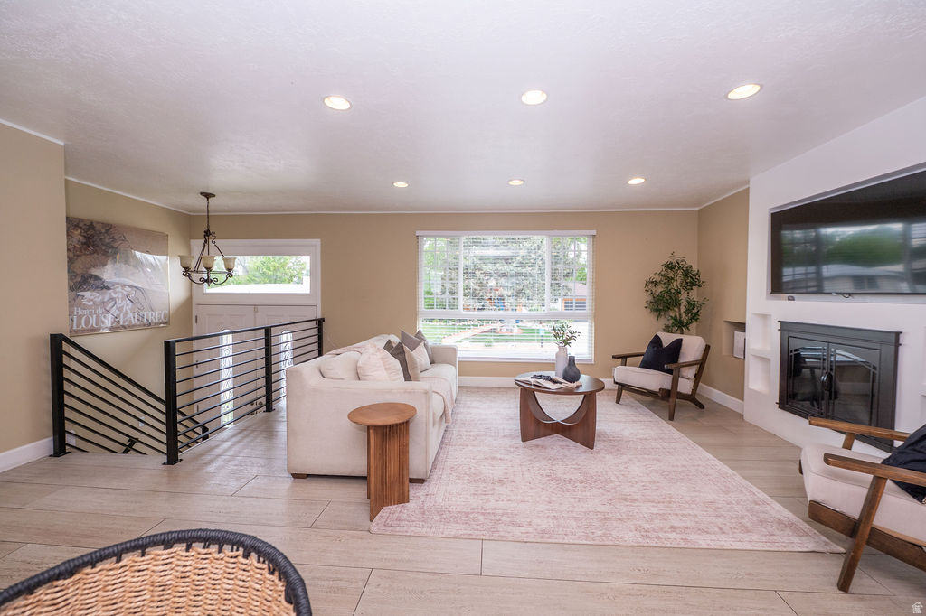 Nestled in the highly sought-after Jamestown subdivision, this beautifully updated home offers the perfect combination of comfort, functionality, and future potential. From the moment you arrive, the impressive oversized statement front doors create a memorable first impression, setting the tone for the thoughtful updates and inviting spaces found throughout.  Inside, the open-concept floor plan seamlessly connects the kitchen, dining, and living areas, creating an ideal space for both everyday living and entertaining. A cozy gas fireplace serves as the heart of the home, while updated bathrooms, modern finishes, and tasteful improvements throughout provide a fresh, move-in-ready feel.  Step outside and enjoy breathtaking mountain views from the newer deck overlooking a meticulously maintained backyard. Mature fruit trees, lush landscaping, and multiple outdoor gathering spaces create a private retreat perfect for relaxing, entertaining guests, or enjoying Utah's beautiful seasons.  One of the home's most exciting features is the incredible flexibility offered by the lower level. Designed with future possibilities in mind, the layout is ideally suited for a potential 2-bedroom, 2-bath ADU complete with space for a full kitchen and dedicated laundry area. Whether you're looking to accommodate multi-generational living, create a private guest suite, generate rental income, or provide extended-stay accommodations, the opportunity is already built into the home's design. Suggested ADU floor plans are included in the listing photos.  Conveniently located just minutes from shopping, dining, entertainment, recreation, and world-class ski resorts, this home delivers both an exceptional lifestyle and an unbeatable location.  Ask for the 3D Matterport tour and experience everything this incredible property has to offer, or schedule your private showing today.
