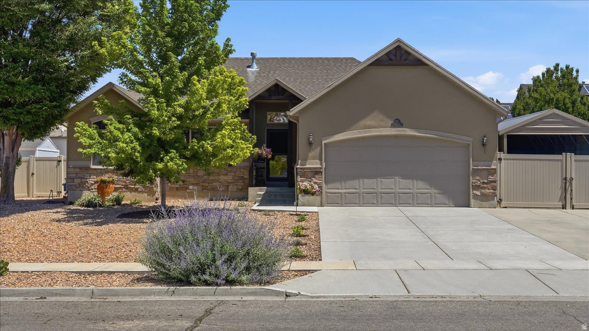Beautifully maintained home featuring stunning landscaping and a versatile floor plan ideal for multi-generational living or an income-producing ADU. With two full kitchens, spacious bedrooms, and separate living areas, this property offers incredible flexibility for extended family, guests, or rental potential. The amazing remodeled main kitchen showcases new cabinetry, Quartz counter tops, stainless steel appliances, a stylish tile backsplash, and opens to a bright living space with vaulted ceilings. Additional features include a radon mitigation system, new carpet, tint on the main floor windows to help with keeping the home cool, RV parking, a 2-car garage, and a detached carport with a workshop-perfect for hobbies, storage, or extra workspace. Enjoy outdoor living on the uncovered patio surrounded by the beautiful, landscaping, including sweet cherry, pie cherry, asian pear, nectarine, peach, and plum trees and golden raspberries, strawberries, grapes, asparagus and much more!  This unique property combines comfort, functionality, and exceptional potential in one outstanding package. Sq. footage per tax data. Property facts are provided as a courtesy; Buyer to verify all information.