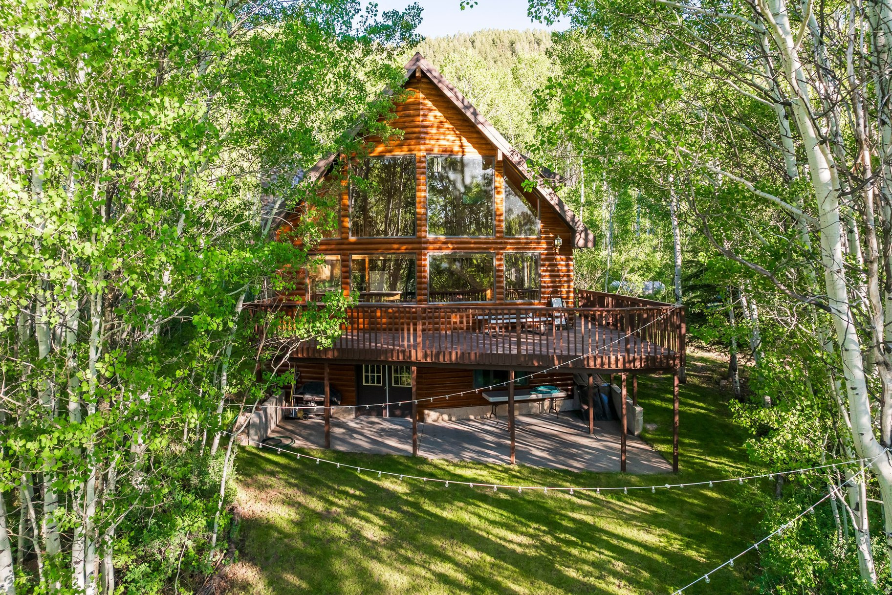 Reconnect with nature, with loved ones, and with the simple pleasures that make mountain living so special. Nestled among the pines and quaking aspens of Weber Canyon near Smith and Morehouse Reservoir and the Weber River, this meticulously cared-for mountain cabin offers a peaceful retreat where the noise of daily life gives way to fresh mountain air, towering trees, and the quiet sounds of nature. Expansive windows bring the outdoors in, capturing beautiful forest views and filling the living spaces with natural light in every season. Start your mornings with coffee overlooking the aspens and vast open meadows below as wildlife wanders nearby. Then, spend your days hiking mountain trails, casting a line at Smith and Morehouse Reservoir, exploring miles of ATV and snowmobile routes, or simply enjoying the solitude and beauty that surround the property. Located in one of Northern Utah's most treasured recreational destinations, the cabin places year-round adventure right outside your door while offering the privacy and serenity that make mountain living so desirable. Unlike many cabins in Weber Canyon, this property combines the feeling of a remote mountain escape with the convenience owners truly appreciate. Situated on the lower portion of Meadow View Ranch, the cabin enjoys year-round access and easy arrivals in every season. The rare flat yard creates an inviting setting for family gatherings, lawn games, evenings around the fire, and making memories with generations of family and friends. The large detached two-car garage provides ample space for vehicles, outdoor gear, snowmobiles, ATVs, and all the equipment needed to enjoy the surrounding mountains. Despite feeling worlds away, you're never far from the best of Utah. Historic Park City's Main Street, Deer Valley Resort, world-class skiing, dining, and shopping are approximately 45 minutes away, while Salt Lake City International Airport is just over an hour from the property. This cabin is a place to gather, rejuvenate, and establish lasting traditions in one of the Wasatch Back's most remarkable mountain settings.