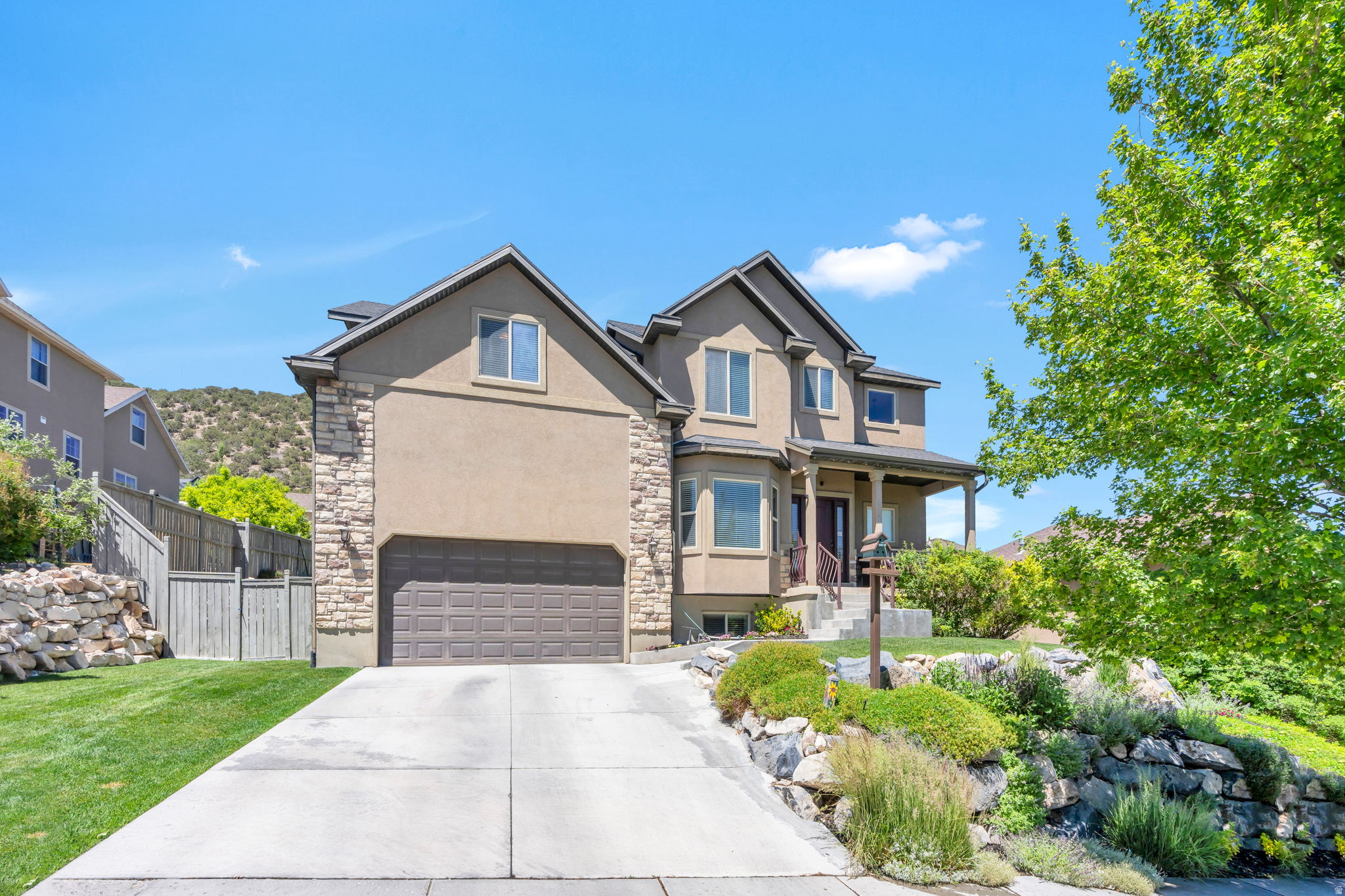 You will love this beautiful well kept home with a breathtaking view of the city and mountains right from your own front porch.  Step inside to a cozy fireplace that creates an inviting atmosphere for relaxation.  The kitchen and bathrooms have beautiful hickory cabinets that never go out of style.  You can cozy up to a good book in the reading nook off the master bedroom with the perfect natural light.  You can get organized with a large walk in closet and full master bath with shower and jetted bathtub.   In the fully finished basement you can enjoy entertaining with the kitchenette and plenty of storage space, you will also have extra storage or parking with the extended garage.  This home has a new water heater, water softener, air conditioning unit and furnace. Step out back to a beautiful trek deck with a shade awning that can be pulled down, surrounded by mature trees.  Nothing is better than to relax on summer nights around the fire pit in the fully fenced backyard.