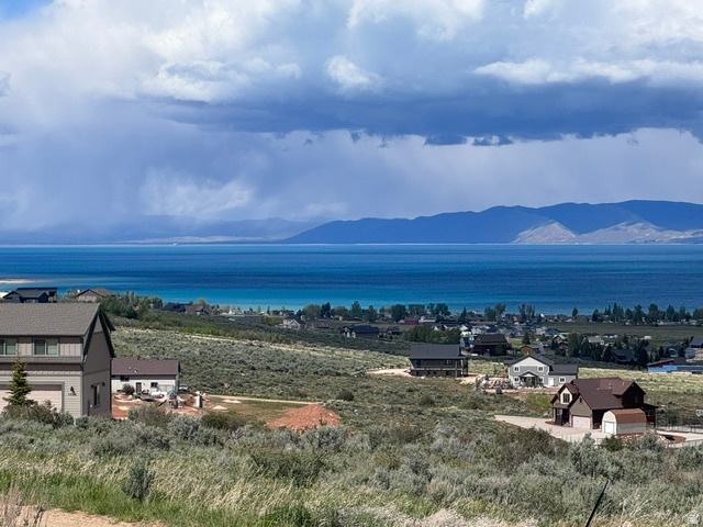 Excellent building lot located in the lower Sweetwater subdivision, tucked into a quiet cul-de-sac for added privacy and peaceful surroundings. This beautiful homesite offers great views of Bear Lake and is conveniently located near the Bear Lake Golf Course, making it an ideal setting for your mountain getaway or full-time retreat. Optional amenities are available through Ideal Beach for an additional fee and include two heated seasonal pools, two year-round hot tubs, miniature golf, beach volleyball, horseshoe pits, sports courts, a beachside playground, kids activity center, expansive lawn areas, and an incredible sandy beach with boat rentals on beautiful Bear Lake. Outdoor recreation is right at your doorstep with direct access to the Hodges Canyon Trailhead, allowing you to explore ATV/UTV and snowmobile trails leading into The Sinks and Cache National Forest without trailering. Nightly rentals are allowed, making this property an excellent opportunity for both personal enjoyment and investment potential. Professional topo ($3,000 value), site plan, house rendering have already been done by seller.  See attached docs.