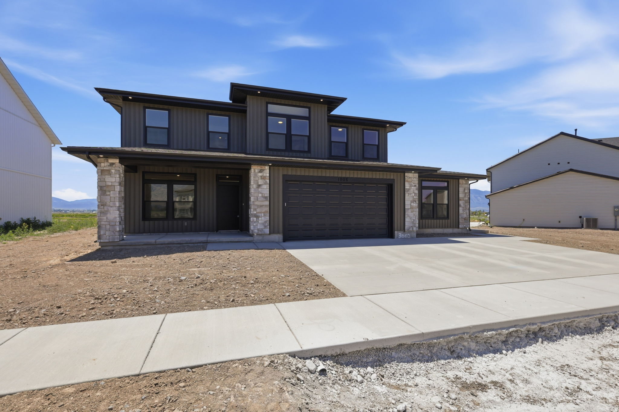 Brand-New Modern Home + ADU! This stylish home is nothing short of luxurious and functional with its attached single-level ADU. Perfect for a rental, Airbnb, or family living with you. The 2422 sqft main home features a dedicated office/den, spacious living room and dining room, an XL kitchen with an abundance of storage, 4 large bedrooms, and a primarily suite that will make you feel like royalty! Huge windows throughout to soak up the unobstructed mountain views and natural light. The 559 sqft ADU has everything you'd need for separate living. Full bathroom, stackable washer/dryer, full kitchen, and a living room. To top it all off the seller will contribute $10,000 towards closing costs when using a preferred lender! 1-year limited warranty included from the builder. Schedule a showing today!