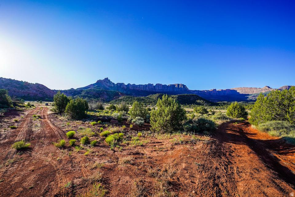 Tucked away in the rugged beauty of Southern Utah, this incredible .70-acre lot near Zion National Park offers a rare opportunity to own a truly off-the-grid piece of paradise in the Rockville area. If your clients are looking for peace, privacy, breathtaking scenery, and a place to escape the noise of everyday life, this property deserves a serious look. Access to the property is by dirt road, and a 4-wheel drive vehicle, truck, or SUV is strongly recommended. This is not a subdivision lot with paved streets and curbs. This is Southern Utah adventure property at its finest. There are currently no utilities or services connected to the property, giving buyers the freedom to create their own recreational retreat while enjoying the untouched beauty of the surrounding landscape. The views from this property are simply spectacular. Enjoy incredible panoramic scenery featuring iconic Southern Utah landmarks including the majestic White Throne, Eagle Crags, and sweeping valley views stretching to the south. The changing colors of the cliffs and mountains throughout the day create a setting that feels different every single time you visit. This property would make an outstanding recreational getaway or basecamp for outdoor adventures. Bring a camper, enjoy weekends under the stars, and explore everything the surrounding area has to offer. Hiking, sightseeing, photography, ATV riding, and exploring the nearby public lands are all right at your fingertips. Opportunities like this are becoming harder and harder to find near Zion. Whether someone is looking for a quiet place to disconnect, a private recreational retreat, or simply wants to invest in a unique piece of land near one of the most recognized national parks in the world, this lot offers tremendous potential and unforgettable scenery. Buyer to verify ALL information.