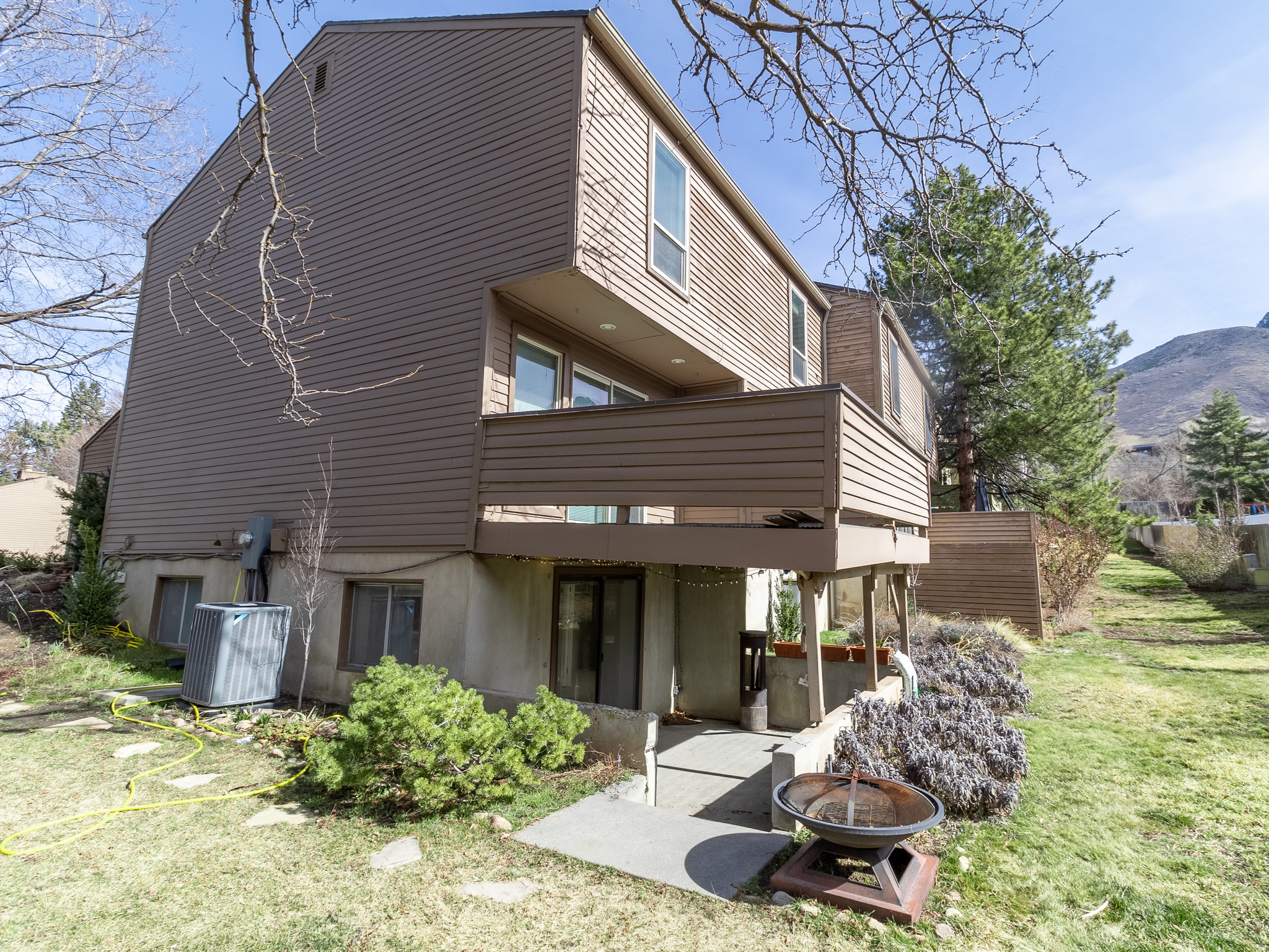Amazing value and location in Cottonwood Heights! $5,000 FLOORING CREDIT! Tucked between Little and Big Cottonwood Canyons this Scandia Village townhome is on a quiet street high on the east bench. If you are looking to be near the outdoors with out-your-door access to skiing, biking, hiking, and climbing this property can not be beat!  Take in the Wasatch Mountain views from the large deck spring, summer, and fall. Or cozy up to the fireplace in the living room with large southern windows for the spectacular view of snowcapped peaks in the winter.   The upstairs master bedroom features a spacious en suite with a double vanity, large closet, tiled shower and built-in washer/dryer! Downstairs you will find a full second kitchen and walkout basement that could be used as a mother-in-law suite or theater room/game room. A second washer and dryer complete this rare full functioning  "apartment".   Brand new hot water heater and nearly new furnace. A spacious 2 car garage with extra storage for all your gear. This  truly is the best value and location in Cottonwood Heights!   Schedule your private showing today!