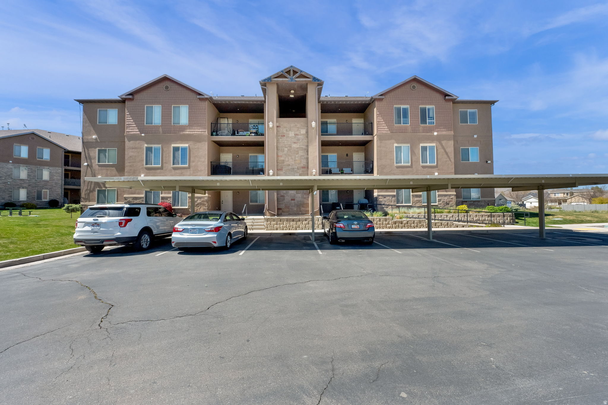 Experience the best of top-level living in this beautiful 1,218-square-foot condominium located in the Rock Creek subdivision of Eagle Mountain. Built in 2007, this residence offers a spacious and functional layout featuring 3 bedrooms and 2 full bathrooms all on a single level. The interior is highlighted by a modern kitchen with granite countertops, a comfortable great room, and a primary suite complete with a walk-in closet. High-quality finishes like laminate and carpet flooring run throughout, complemented by the convenience of central air and fiber-optic internet. The community lifestyle is unmatched, with an HOA that covers an extensive list of amenities and utilities including a clubhouse, gym, swimming pool, playground, and picnic areas. Maintenance is a breeze as the monthly fee also handles snow removal, trash, and water. Outside, you can enjoy a private patio and the benefit of both covered and uncovered parking spaces. Located within the Alpine School District and near Pony Express Elementary, this pet-friendly home is perfectly situated for those seeking comfort and community. Square footage figures are provided as courtesy estimates only and were obtained from county records. Buyer is advised to obtain an independent measurement.