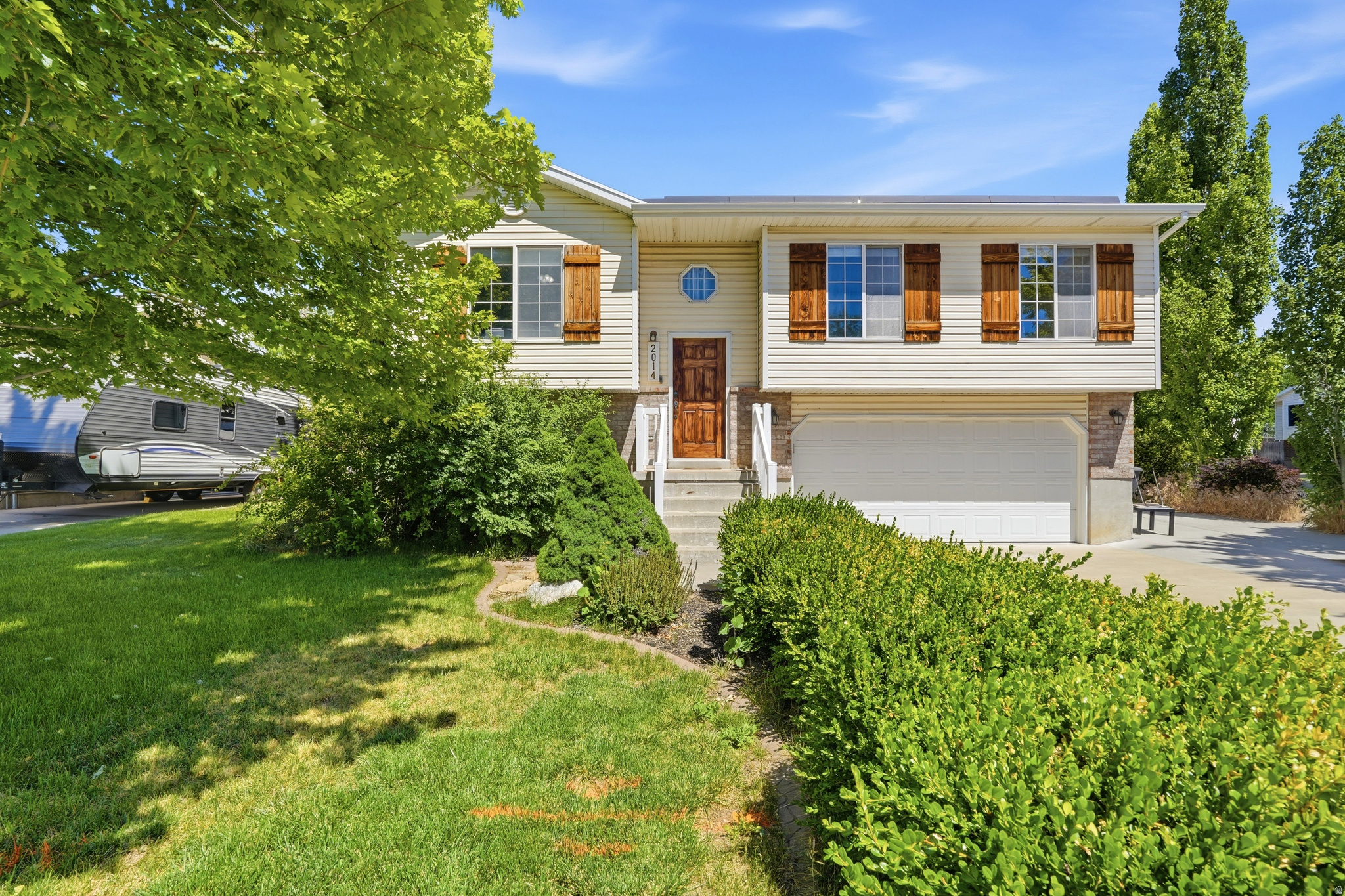 Sitting on a corner lot in Clinton with mature, established landscaping, this one is move-in ready and built for real life. The primary bedroom has a walk-in closet. Step out the sliding glass door onto a Trex deck with vinyl railing that you'll never have to stain or seal, into a big fenced backyard that's made for summer nights and weekend get-togethers. Parking is never a problem here. Two-car garage, a large driveway, and an RV pad for the boat, the trailer, or the toys. The numbers make sense too. A fully owned solar panel system means your power bill stays low month after month, with no lease payment hanging over the panels.  You're minutes from schools, restaurants, and shopping, and only ten minutes from Hill Air Force Base. Schedule your private showing today!