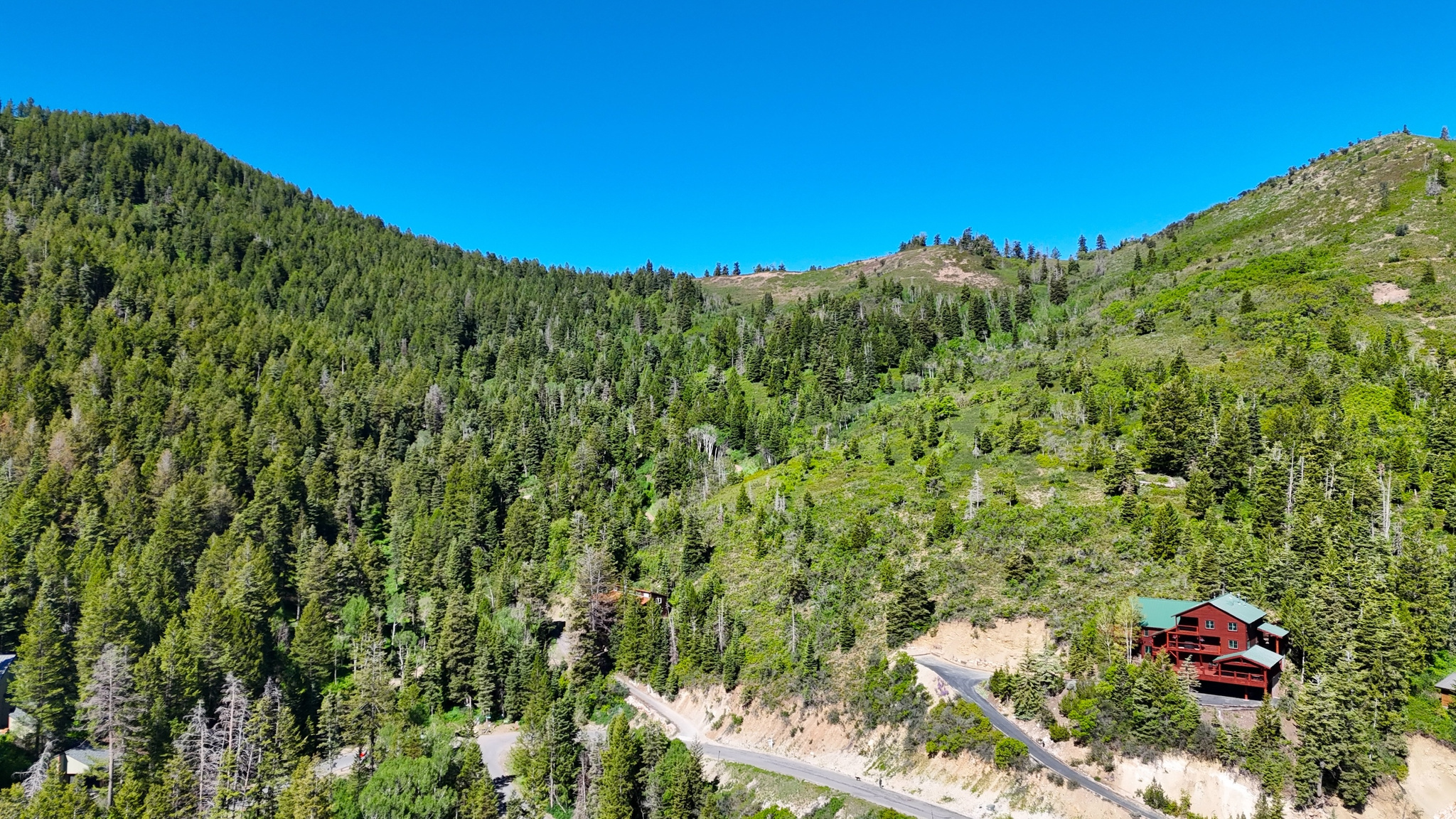 Prime uphill south facing lot with house plans included on one of Summit Park's quietest streets! Backing directly to open space and just steps from the Parkview trailhead, this property offers rare ski-in access in winter and effortless hiking and biking in summer-no car required. Summit Park is known for its extensive trail system and premier backcountry skiing.  An exceptional value with both mountain and valley views in one of Park City's most desirable neighborhoods. Located within the Park City School District and just minutes from Deer Valley, Park City Mountain Resort and Woodward. Save time and money with included plans for a three-bedroom, four-bath home featuring multiple dens and an open-concept living and kitchen area. Roads are county-maintained, and public utilities available. Don't miss this opportunity to build your mountain retreat in the heart of the Wasatch. HOA is voluntary. For more information, visit www.summitparkutah.net.
