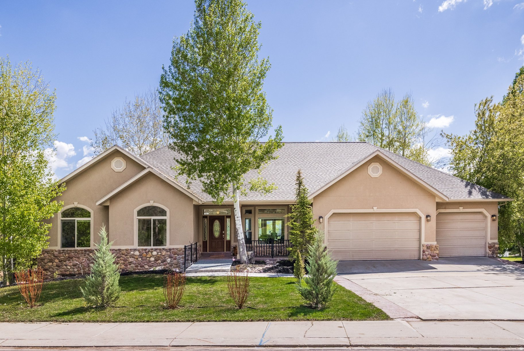 Price reduced! Beautiful home in Midway with a huge backyard and great views! Positioned on the west side of Midway with open valley and mountain views, this five bedroom home features vaulted ceilings, abundant natural light, and an open floor plan connecting the kitchen, dining, and family room. The main area opens to a large covered deck, creating seamless indoor-outdoor flow and a quiet setting overlooking the fully fenced backyard, mature trees, and garden area. The main level includes a spacious primary suite, two additional bedrooms, and a layout designed for ease and functionality. The lower level offers excellent versatility with a second kitchen, a large great room, two additional bedrooms, and flexible space for guests, recreation, or extended use, along with a dedicated exercise room, workshop, and substantial storage. The backyard is generous and usable with a large lawn and multiple outdoor areas, while the oversized garage with epoxy floors provides ample room for vehicles and recreational equipment. Located in a quiet neighborhood, this home combines views, privacy, and function in a beautiful and quiet Midway setting.