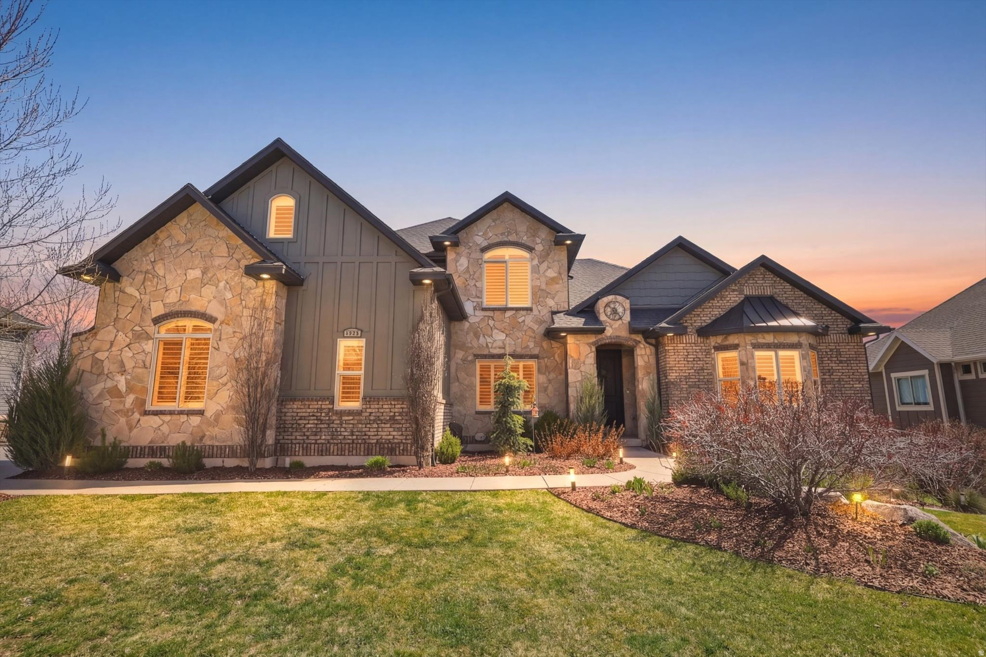 This beautiful, custom-built home in Mountain Green sits just 10 minutes South of Snowbasin Ski Resort where the Downhill, Super-G, and other Olympic events will be held. It offers breathtaking mountain views and is nestled on a quiet street. With over 5,500 finished sq feet you'll immediately notice the great room with vaulted ceilings, spacious and open floor plan with ample natural light.The primary bedroom and office are on the main floor with three more large bedrooms on the 2nd floor and two bedrooms in the basement.. The primary suite is a true sanctuary. Offering a spacious bedroom, a fully remodeled, luxurious ensuite bathroom with a soaking tub and separate shower. The large walk-in closet contains its own washer and dryer. Home chefs will appreciate the updated kitchen featuring a large 48" Thermador Range with steam and convection ovens, Thermador dishwasher, pot filler, and a large hidden pantry. The large basement includes a kitchenette, theater room, gym, two bedrooms, bathroom, and plenty of storage space.. The theater room is set up with a projector, surround sound system, and all of the theater furniture is included with the home.  The large lot boasts almost a third of an acre and is perfectly situated to enjoy the mountain views from the covered back deck. The backyard is fully fenced and offers beautifully maintained yard with raised garden beds, raspberry bushes, black berry bushes, grape vines, and a stunning tulip garden. Professional landscape lighting is featured in both the front and backyard. In addition to the oversized three car garage, there is plenty of room in the loft for extra storage. RV parking on the side of the house. This home was meticulously designed to feel spacious and clean.  Since then, it has been carefully maintained and is move-in ready for the new homeowners.   Square footage figures are provided as a courtesy estimate only and were obtained from appraisal.  Buyer is advised to obtain an independent measurement.