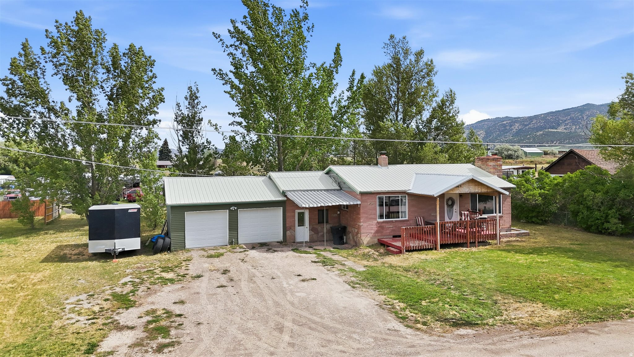 This 1960 brick home in Grace, Idaho has been well cared for and updated in the right places. It offers 4 bedrooms and 2 baths with an open layout on the main floor and durable LVP flooring throughout. The kitchen has granite countertops, and there are fireplaces on both levels for easy warmth during Idaho winters. A mudroom off the entry helps contain the mess from boots, coats, and outdoor gear, while extra storage on the main floor and in the basement keeps things organized without clutter. The oversized two-car garage gives you room beyond just parking-plenty of space for vehicles, tools, or toys. Out back, the large yard provides room to spread out for play, gardening, or whatever you have in mind. Newer furnace and water heater are already in place, so those big-ticket items are current. Situated on a dead-end street, it sees less traffic than busier spots. Call to schedule your own private showing today!