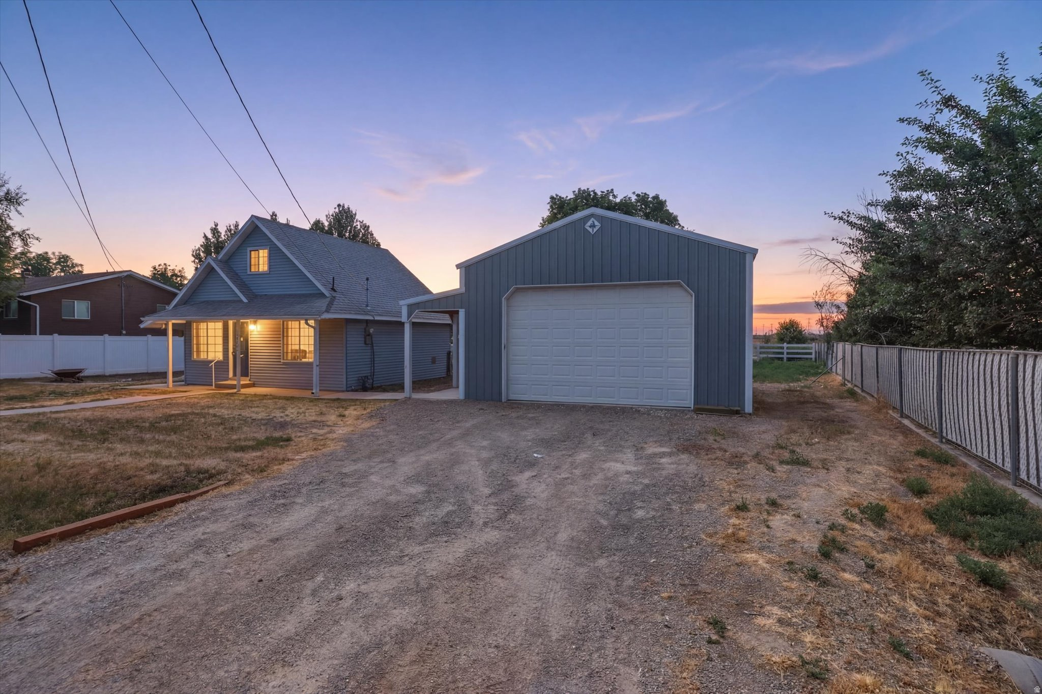 Enjoy the best of country living on this beautifully maintained 0.36-acre property in Plain City. This inviting home makes the most of its space with fresh paint, new flooring, a private upstairs bedroom with a walk-in closet, and a versatile flex area on the main level that's perfect for a home office, reading nook, craft area, or workout space. The detached deep two-car shop/garage offers plenty of room for vehicles, storage, hobbies, or weekend projects. Outside, you'll find mature landscaping complete with peach trees, established grapevines, secondary irrigation water, and a partial automatic sprinkler system to help keep everything looking its best. Two additional storage buildings provide even more room for tools, equipment, or gardening supplies. Relax on the covered patio while taking in the mountain views and peaceful surroundings. With no HOA, country charm, and exceptional outdoor amenities that are hard to find, this move-in ready property is one you won't want to miss.  *Be sure to view the virtual tour in the listing. Square footage figures are provided as a courtesy estimate only and were obtained from an appraisal.  Buyer is advised to obtain an independent measurement.