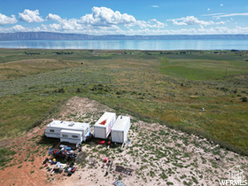 The views from this lot is end to end lake. This property is paradise in Bear Lake. Sitting on a mountain top with your RV's, bring your whole family, every friend you've ever made and enjoy riding your ATV's on your own land. Spend the day on the lake, the evening with views that will blow your mind. There is already a large cleared area for your trailers or to build on. Remote, yet close. There is a easy beach access just across the Hwy