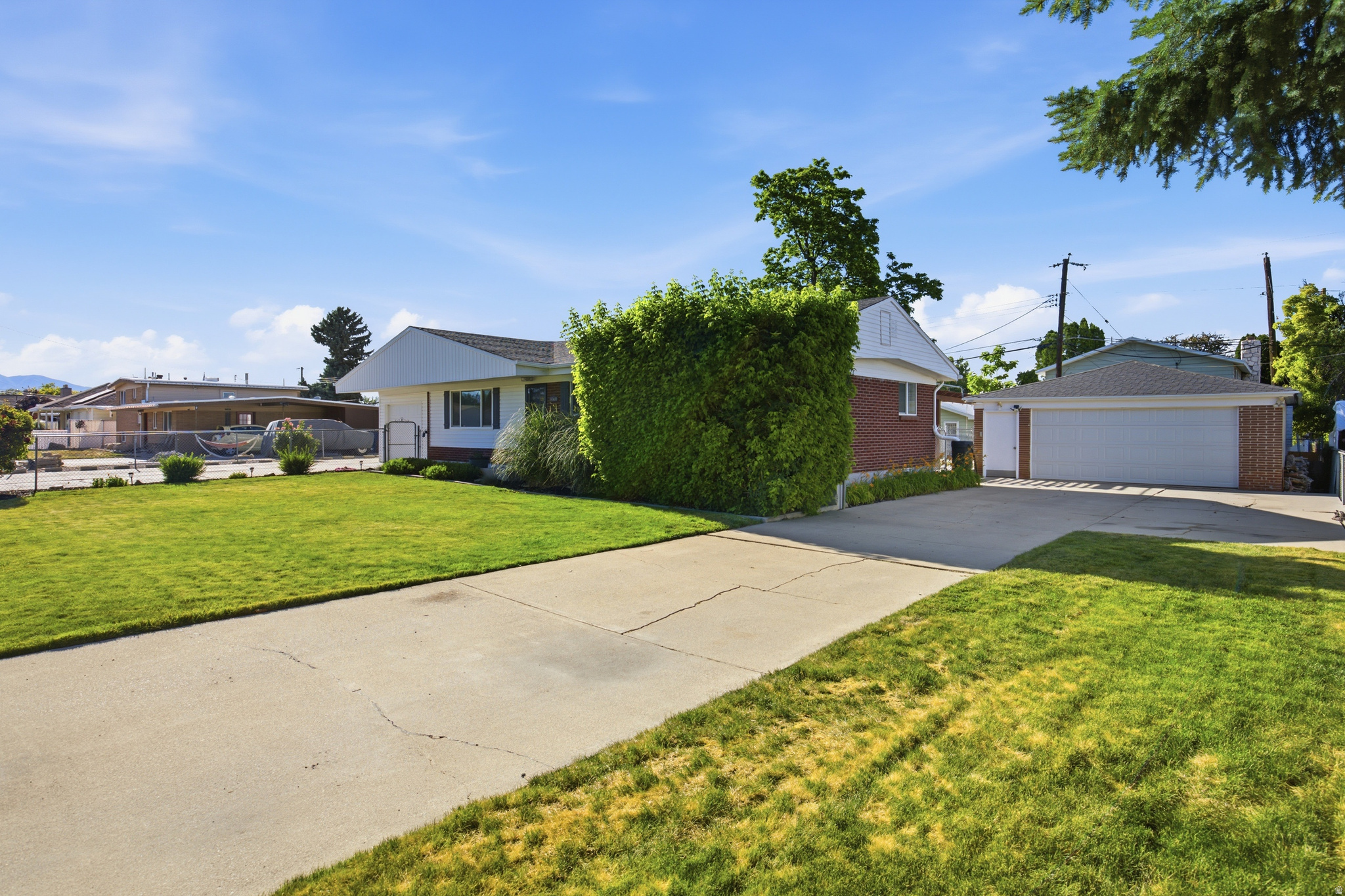 Welcome home to this beautifully maintained 6-bedroom, 3-bathroom rambler in the heart of Taylorsville, where location truly speaks for itself. Tucked into a well-established neighborhood with breathtaking Wasatch Mountain views visible right from your own backyard, this home has the space, the upgrades, and the character to make every buyer stop scrolling. The kitchen has been completely transformed and it shows. White shaker cabinets, quartz countertops, a full tile backsplash, stainless steel appliances, and a stunning exposed wood beam that ties the whole space together with warmth and style. The breakfast bar opens right into the dining area, making it perfect for entertaining or keeping an eye on the family while you cook. The main level living spaces feature new LVP flooring, recessed lighting, and gorgeous custom built-in shelving. A cozy wood-burning stove set on slate tile adds a bonus room all its own. Bedrooms are bright and generously sized with new carpet, ample closet space, and updated bathrooms with new vanities and modern matte black fixtures throughout. Downstairs, the fully finished basement delivers serious square footage. A sprawling rec room with new carpet anchors the lower level, with additional bedrooms, closets, two bathrooms including a tiled walk-in shower, and a dedicated laundry room. Whether it becomes a guest suite, teen hangout, or multi-generational living space, the basement is ready for whatever you need. Step outside and the backyard will not disappoint. A beautiful pergola shades the patio, natural stone retaining walls create terraced levels with real character, raised garden beds are ready for your green thumb, and sweeping mountain views make every evening feel like a retreat. Two driveways, a 3-car garage, and RV parking round out a package that is truly hard to beat. The big-ticket items are already done. New HVAC (2020), new windows (2020), water softener (2021), and new front siding (2022) give you complete peace of mind from day one. Close to top-rated schools, shopping, and freeway access. Homes this dialed in at this price point in Taylorsville do not last. Come see it before it is gone.