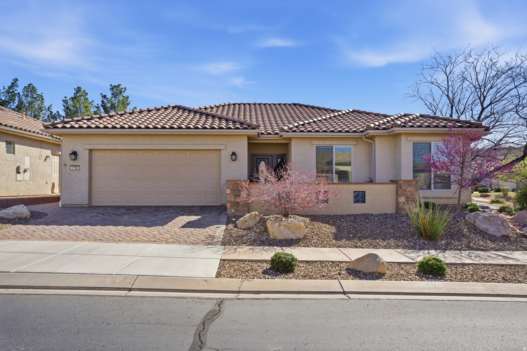Huge price improvement! Welcome to effortless living in this beautifully remodeled home located in the beautiful Sun River community, a desirable 55+ neighborhood surrounded by breathtaking red rock landscapes. This stunning 3-bedroom, 2-bath residence has been fully renovated with high-end finishes and thoughtful design throughout. From the moment you arrive, the paver driveway and entry, immaculate landscaping, automatic yard lights, and fully fenced yard create exceptional curb appeal and privacy. A drip irrigation system keeps the landscaping lush while maintaining easy, low-maintenance care.  Inside, you'll find a bright, open layout featuring elegant built-ins, crown molding, gorgeous quartz countertops, and a cozy fireplace that anchors the main living space. The kitchen shines with upscale finishes, cupboard and under-counter lighting, and a large kitchen pantry, offering both style and functionality for everyday living or entertaining. A dedicated laundry room adds convenience, while automatic blinds and quality craftsmanship enhance comfort and sophistication throughout the home.  Step outside to your private oasis - a fully landscaped backyard complete with a soothing water feature and a large covered patio, perfect for relaxing mornings, evening gatherings, or simply enjoying the stunning red rock views.  Additional highlights include a spacious 2-car garage and low-maintenance landscaping designed for easy living. Ideally located just 40 minutes from Zion National Park, you'll enjoy quick access to world-class hiking, biking, and endless outdoor adventures - all while coming home to peaceful community living.  This is desert living at its finest - beautifully upgraded, perfectly located, and ready to welcome you home.