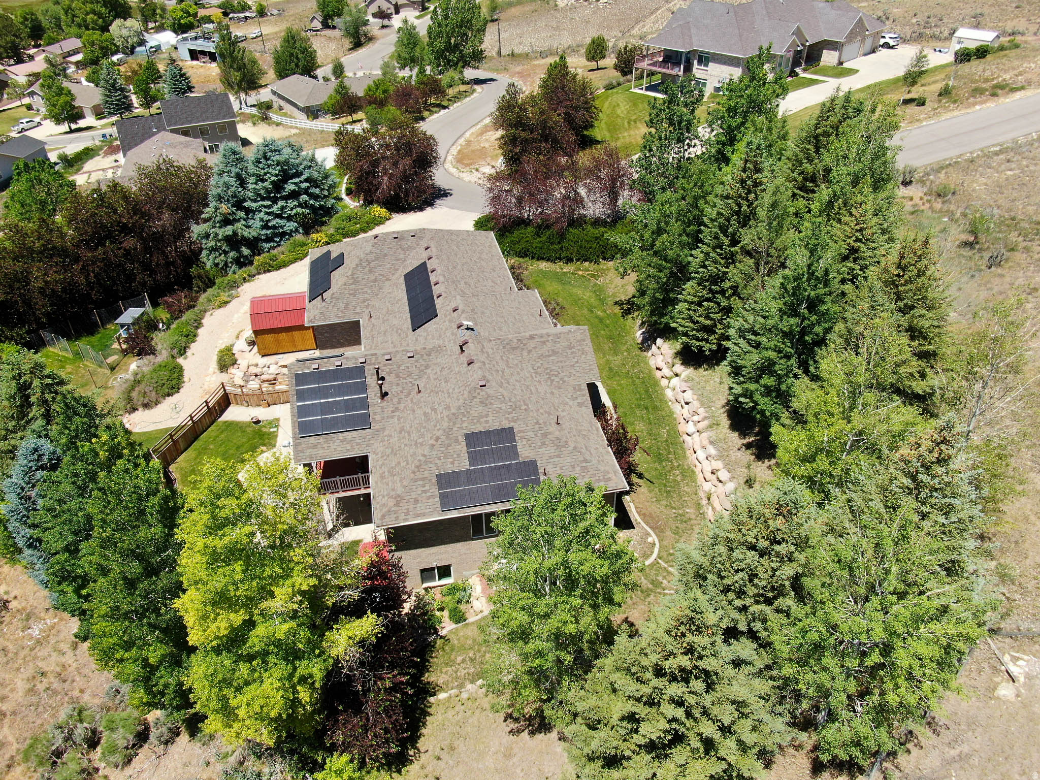 If you know, you know. And then you'll schedule a private showing--Today!....Built by the original owner for his personal residence, this 4,071 sq. ft. all-brick home offers a quiet, small-town country living feel with a mature, private yard, yet sits within an efficient commute to Salt Lake City and Park City. The location serves equally well as a permanent local residence or an easily accessible, low-maintenance second home with rapid proximity to world-class recreation, dining, and shopping. This property ''lives remote'' but is close to everything, sitting just minutes from Echo and Rockport Reservoirs for power-boating, foiling, sailing, and fishing. Door-to-door travel times include: Kimball Junction & Woodward Park City (20 Min.); Park City's Historic Main Street (25 min.); Canyons Resort & Jordanelle Reservoir (28 min.); Deer Valley Resort (30 min.); downtown SLC (40 min.), Heber Valley & Evanston airports (40 min.); Snowbasin Resort (43 min.); Salt Lake City International Airport (45 min.) For the outdoor enthusiast or hobbyist, the heated, fully finished 1,386 sq. ft. 4-car garage features 8-foot doors, high ceilings for a vehicle lift, workbench, custom knotty alder cabinets, floor drains, hot/cold water, an exterior RV pad, and a direct interior stairway to the lower level. Inside, the main floor provides true single-level utility with a primary suite, laundry, The main kitchen features custom knotty cherry cabinets. The lower level operates as a fully independent living space or guest suite, complete with its own full knotty alder full kitchen, two gas fireplaces, and an amazing & unique 155-inch 3D home theater setup. Mechanical/structural updates include a new roof and a new solar system (owned) installed in 2024. The functional exterior grounds include a Certificate of Entitlement for use of the Coalville City Secondary Water System which transfers with the property. There is also a greenhouse, storage shed, covered patio, and a covered deck with expansive valley views. This property is an exceptional value, so don't delay!