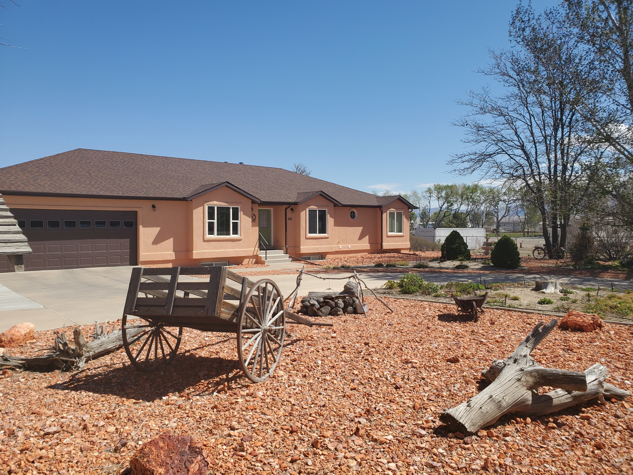 ONE-OF-A-KIND SOUTHERN UTAH DREAM PROPERTY   Luxury  Privacy  Space  Comfort  Adventure Welcome to this exceptionally maintained 4,700 sq. ft. custom rambler nestled on 1.05 fully landscaped acres within Milford City limits.   Built in 1997 with timeless craftsmanship and meticulous care, this stunning 5-bedroom, 3-bath estate offers the perfect blend of luxury living, peaceful privacy, and unmatched functionality. Set back from the street for a quiet, secluded feel, this home immediately impresses with its expansive layout, mature landscaping, and elegant curb appeal. Inside, you'll find warm custom oak cabinetry throughout, spacious living areas, tasteful neutral finishes, and premium built-in storage designed for both beauty and convenience.   The oversized chef's kitchen features abundant custom cabinetry, expansive counter space, a large center island with built-in seating, and an adjoining dining/sitting area perfect for entertaining family and guests.  A large centrally located living room provides plenty of space for visiting with family and friends. The room contains a wood burning stove capable of heating the entire main level in the event of an extended loss of power.  The spacious primary suite offers a relaxing retreat complete with a large jetted tub, while all upstairs bedrooms feature professionally installed closet organizing systems. A custom executive office/den showcases stunning oak built-ins, bookshelves, and a built-in desk ideal for working from home.   The fully finished basement expands the home's versatility with:  2 additional bedrooms  Large family room  Game room and Dedicated Exercise room (both rooms could easily be turned into bedrooms)   Walk-out basement access  Massive food storage room with built-in shelving and chest freezer  Additional storage room with sink and kitchenette potential     Car enthusiasts, hobbyists, and outdoor adventurers will appreciate:  Attached 1,000 sq. ft. finished garage with built-in shelving  Detached 900 sq. ft. stucco workshop/garage with benches, shelving, and dual roll-up doors  Large circular driveway  Extended 200 ft. gravel driveway with extensive RV & equipment parking   The outdoor amenities are truly incredible:  Fully landscaped 1.03-acre lot  Mature trees and established shrubs  Approximately 3,600 sq. ft. of garden space    Automatic sprinkler system  Decorative rock landscaping  Large playground with Cedar Works play set    Fire pit & picnic area    Horseshoe pits  Fountain/bird bath    Fully stocked woodshed     Major upgrades include:   New roofs on home and detached garage (2021)   New front windows (2022)   Fiber optic internet availability   Central air & forced air gas heat   Outdoor recreation is right at your doorstep. Ride your ATV directly from the property and access hundreds of miles of scenic Southern Utah trails, mountain roads, historic mining camps, ghost towns, and beautiful desert landscapes. This extraordinary property offers the rare opportunity to own a luxury home with space to entertain, garden, explore, work, and create lifelong memories - all in one remarkable setting.   Seller is including the chest freezer in the food storage room and the weight machine in the exercise room. Square footage figures are provided as a courtesy estimate only.  Buyer is advised to obtain an independent measurement.