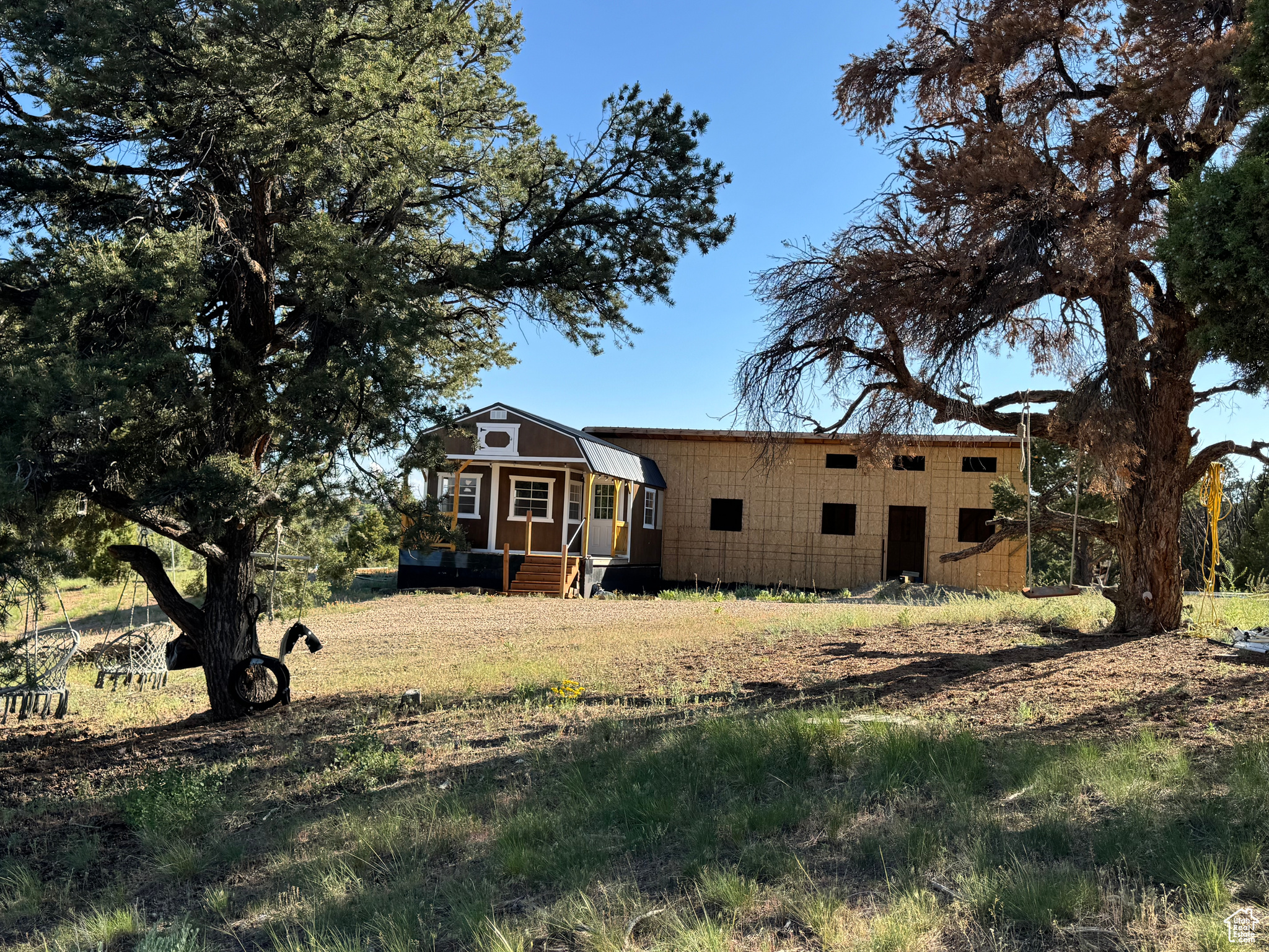 *sq ft is an estimate - 640 sq ft cabin and an estimated 400  sq ft addition.   Escape to the mountains on over 5 acres in the scenic Bandana Ranch community in Fruitland!   This charming cabin is currently under construction and includes a prefab cabin for kitchen, family room, loft for sleeping on a foundation-with a recent addition that has is framed and roofed for a bunkhouse with large windows, a bathhouse or  laundry/ mud room. and crawlspace underway. On the back side of the bunkhouse addition it can have a carport or large covered patio area. Enjoy year-round access with HOA-maintained roads and snow removal. Water is already at the property. Strata internet or starlink so you can work from home.   Fruitland water brought in and stubbed to property at road. Septic  Tank is in.  Moon Lake Electric Power is quoted and approved to come over from main road. propane will be needed. e.  Seller's were planning on : main cabin -1 bedroom -full kitchen- family.. room and bathroom. -1 full with bunk  & 4 bunks sized queen/ full in the add on bunkhouse  and laundry/mud room   Property is Surrounded by trees and mountain views, this private retreat offers the perfect place to relax on the covered front deck or gather around the fire pit. Flat areas provide room for trailers, RVs, or additional outdoor activities.   Located just minutes from Red Creek Reservoir, Strawberry, Starvation, and BLM land, it's ideal for fishing, kayaking, ATV riding, or simply enjoying the abundant wildlife including deer, elk, and moose. A perfect mix of recreation and relaxation! Buyer to verify square footage and building plans.    **Square footage figures are provided as a courtesy estimate only and were obtained from seller's estimated plans.  Buyer is advised to obtain an independent measurement.