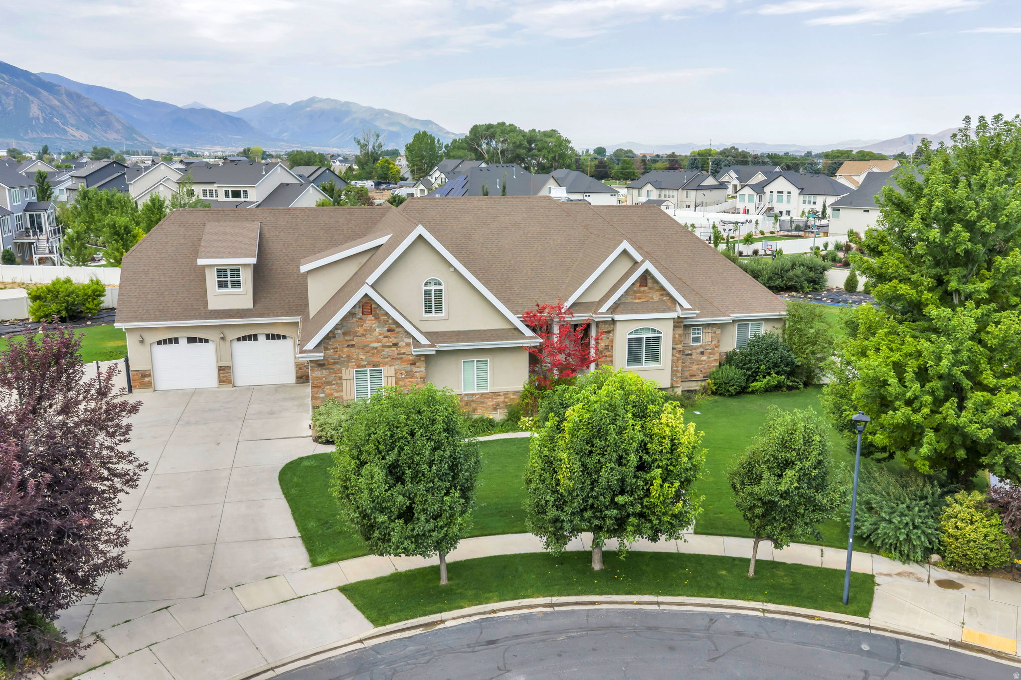 If location matters, this is the home you've been seeking. Capture breathtaking mountain views from this exceptional Mapleton estate, where refined luxury, thoughtful design, and comfortable living come together seamlessly. With 7 spacious bedrooms and 5.5 beautifully appointed bathrooms, the home offers generous scale and versatility to support both everyday living and memorable gatherings.  At the heart of the home, the gourmet chef's kitchen is as inspiring as it is functional, featuring a large, built-in, double door refrigerator, premium finishes, and a discreet walkin pantry that blends elegance with practicality-perfectly suited for everything from quiet mornings to hosting special celebrations.  Designed with connection and flexibility in mind, each level of the home features expansive gathering spaces, offering inviting settings to come together with friends, loved ones, and the people who matter most. These thoughtfully designed areas provide a blank canvas-allowing you to shape each space according to your own vision, whether that means vibrant entertaining areas, relaxed conversation zones, or serene retreats throughout the home.  Additional highlights include a music room, a custom builtin office ideal for working from home, and multiple living spaces that easily adapt to your lifestyle-giving you the freedom to create environments that reflect how you live, work, and connect.  Entertainment and recreation are elevated with a private theater room, a large open game and gathering area, and a dedicated space ideal for an exercise studio or golf simulator, offering the flexibility to design leisure experiences that suit your personal interests-all under one roof.  Step outside to an extraordinary backyard oasis where beauty meets abundance. Enjoy a private orchard with peach, apricot, apple, pear, plum, and nectarine trees, alongside thriving raspberry, boysenberry, and blackberry bushes. A spacious garden with drip irrigation and a charming garden shed enhance the opportunity for sustainable, farmtotable living and outdoor enjoyment.  Every element of this home reflects quality, comfort, and timeless elegance, beautifully set in one of Mapleton's most soughtafter locations-ready to be shaped into a living experience that is uniquely your own.