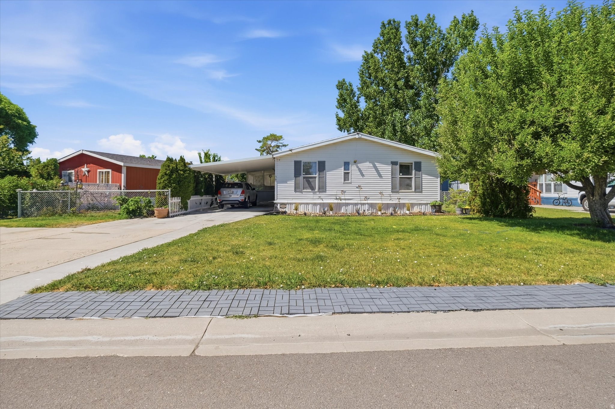 Welcome home to this charming 4-bedroom, 2-bathroom Cavco double-wide mobile home located in the desirable Town and Country Estates. This property features a spacious layout with a walk-in shower, a cozy built-in fireplace, and a fully fenced yard. Enjoy peace of mind with a roof replaced just two years ago and a brand-new central air conditioning system. Complete with an extra-wide 1-car carport and a large backyard storage shed that stays with the home, this is an excellent opportunity for affordable family living!  Square footage figures are provided as a courtesy estimate only and were obtained from mobile home dimensions on title.  Buyer is advised to obtain an independent measurement.